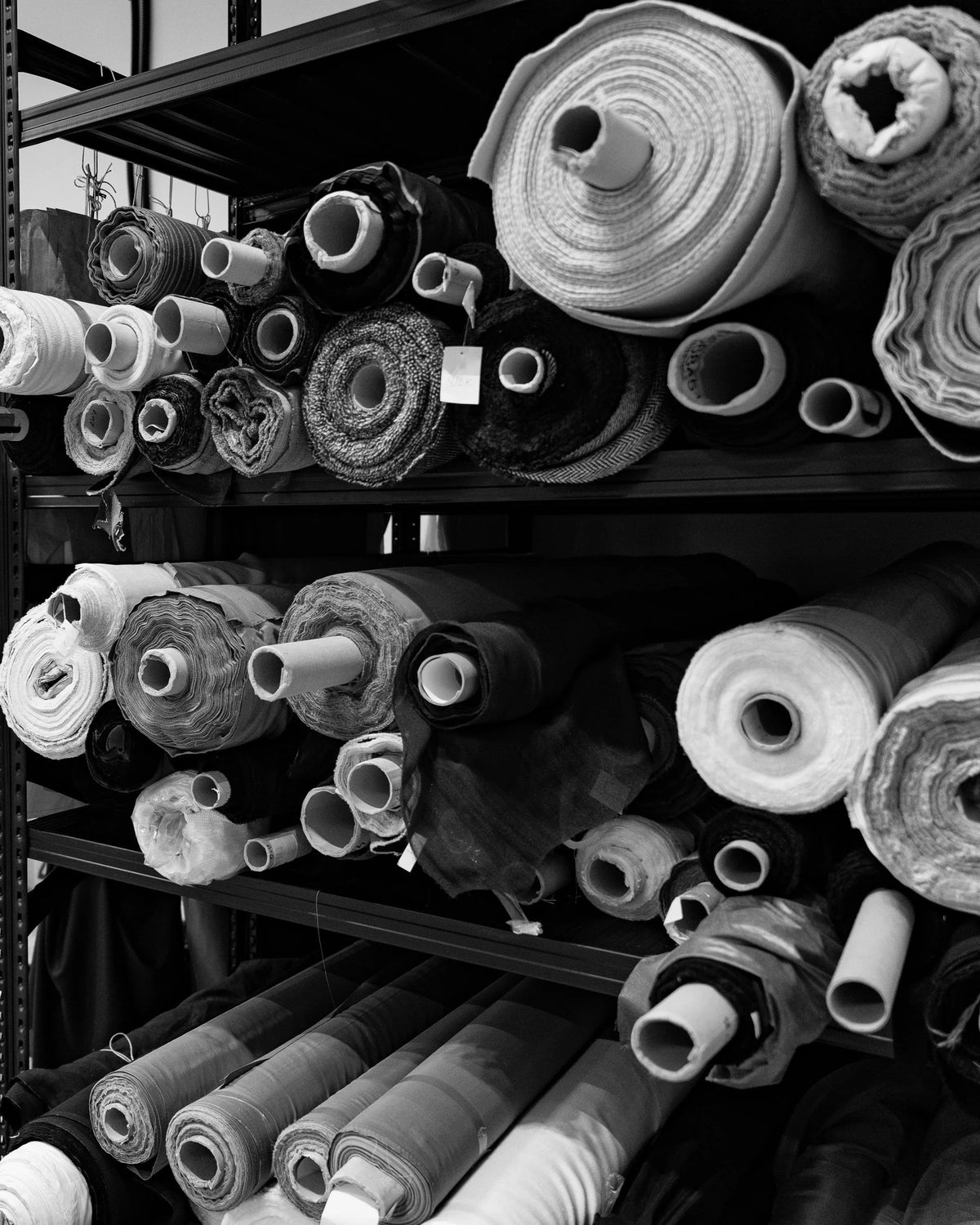 Rolls of fabric on the atelier shelves