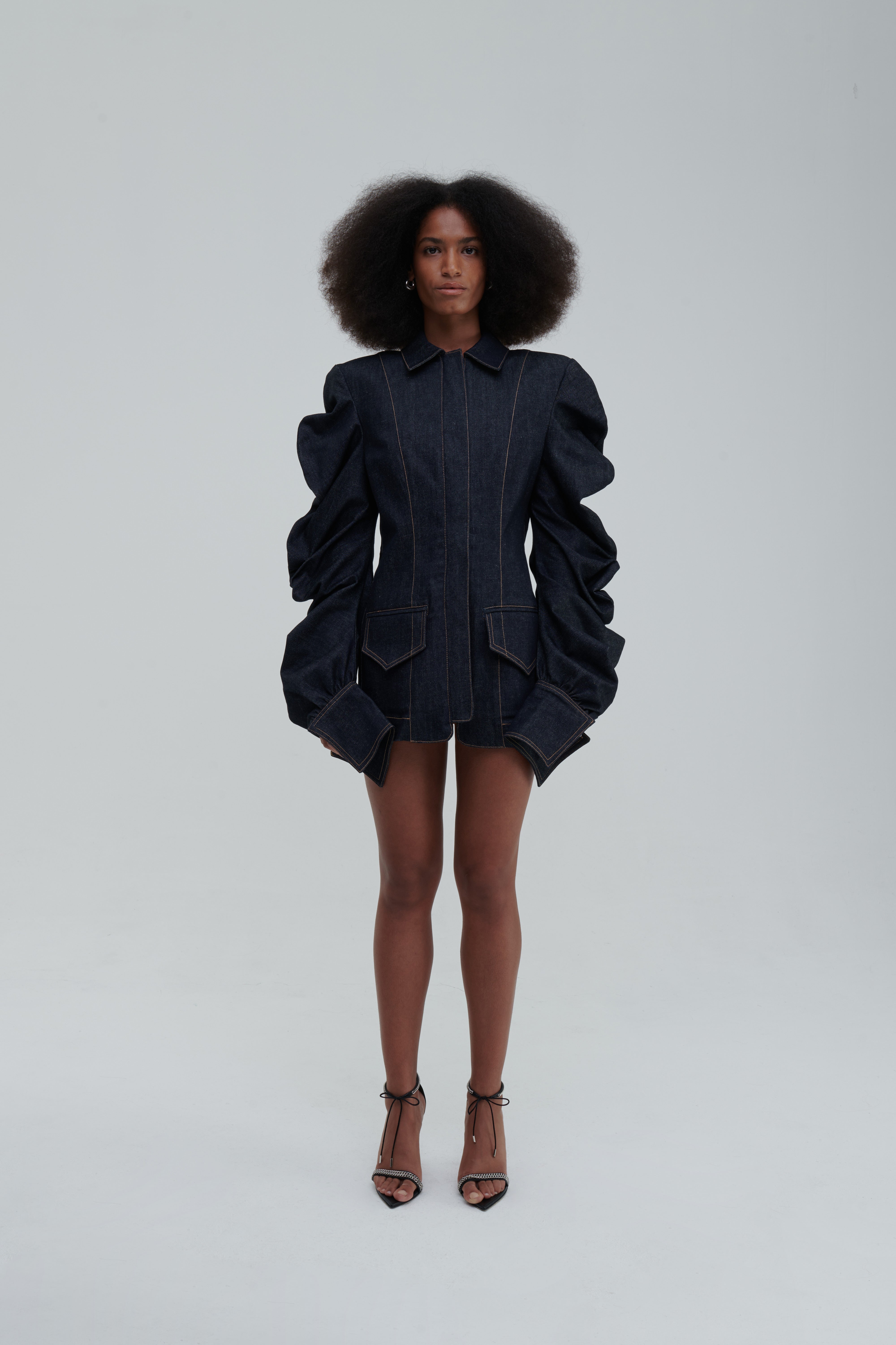 MEDUSA DENIM PARKA by Sagio from the Spring/Summer 2025 collection — a structured, sculptural denim parka with voluminous sleeves, architectural draping, and an avant-garde silhouette. Explore modern statement outerwear at thesagio.com