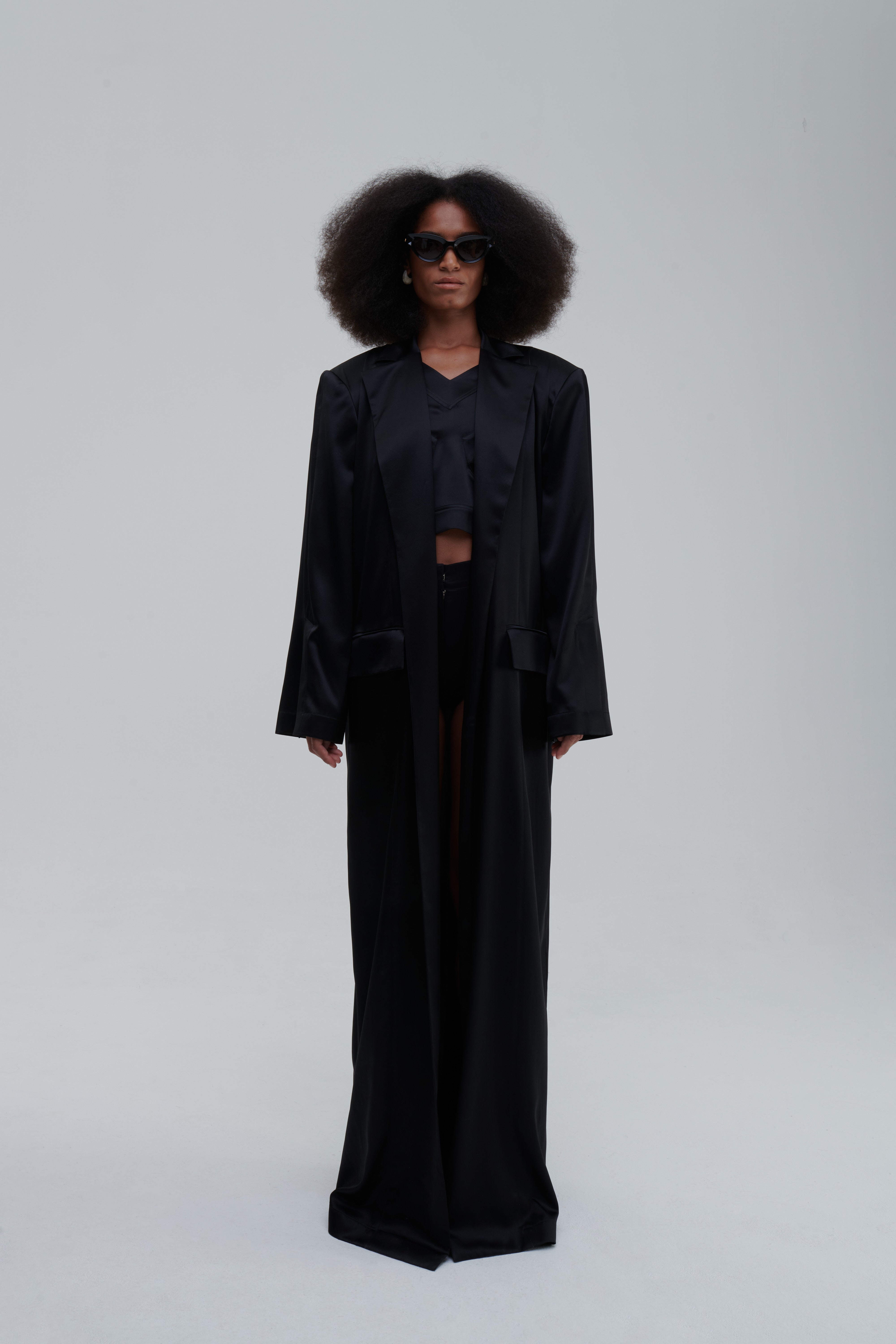 SILK LONG COAT by Sagio from the Spring/Summer 2025 collection — a full-length, flowing silk coat with a minimalist cut, subtle sheen, and relaxed tailored fit. Elegant and lightweight outerwear by thesagio.com