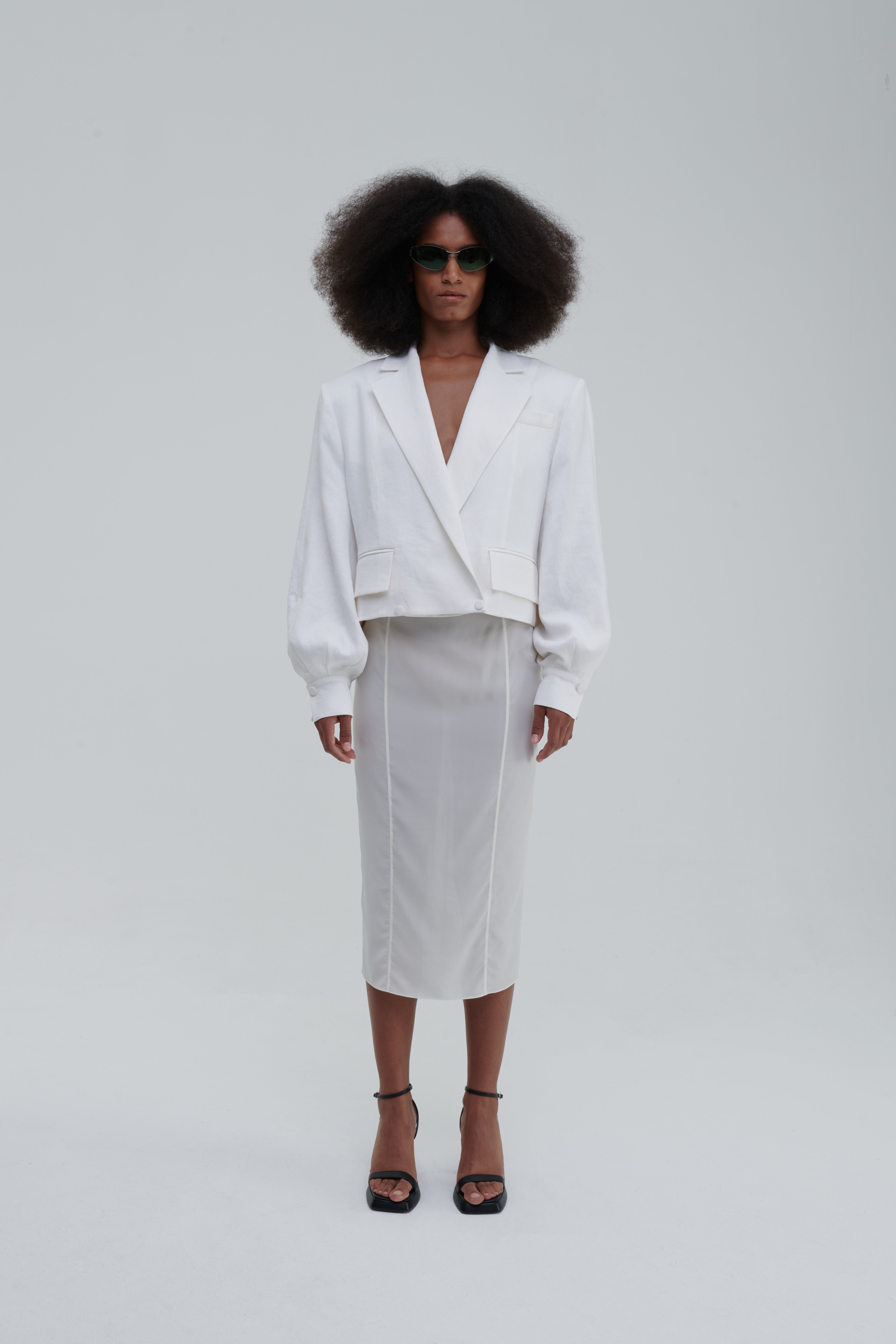 TRANSPARENT SILK SKIRT by Sagio from the Spring/Summer 2025 collection — a sheer, flowing silk maxi skirt in ivory white, designed with soft pleats and ethereal movement. Lightweight and elegant designer womenswear from thesagio.com