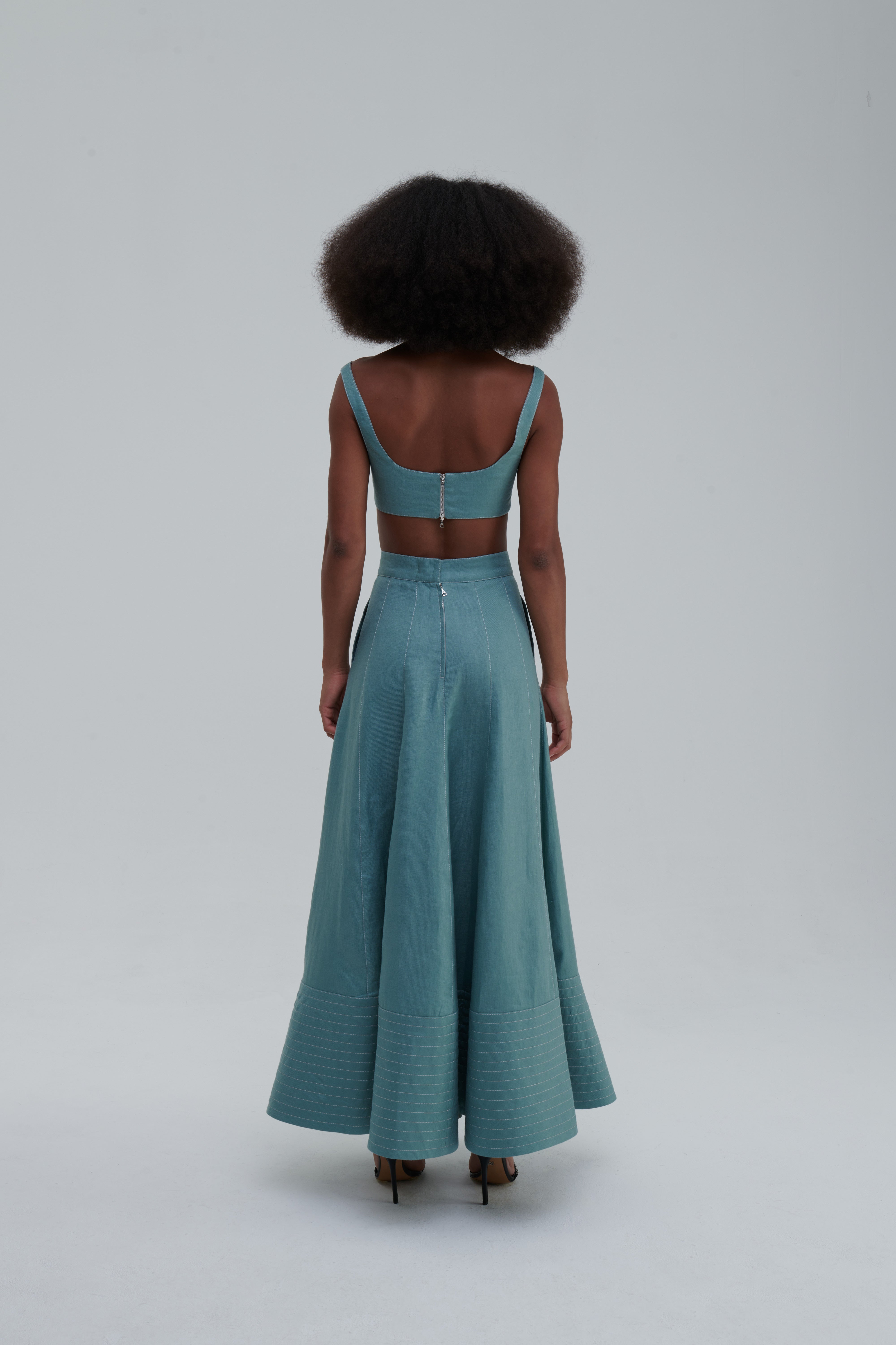 Green Bay linen maxi skirt with quilted hem, side view on-model