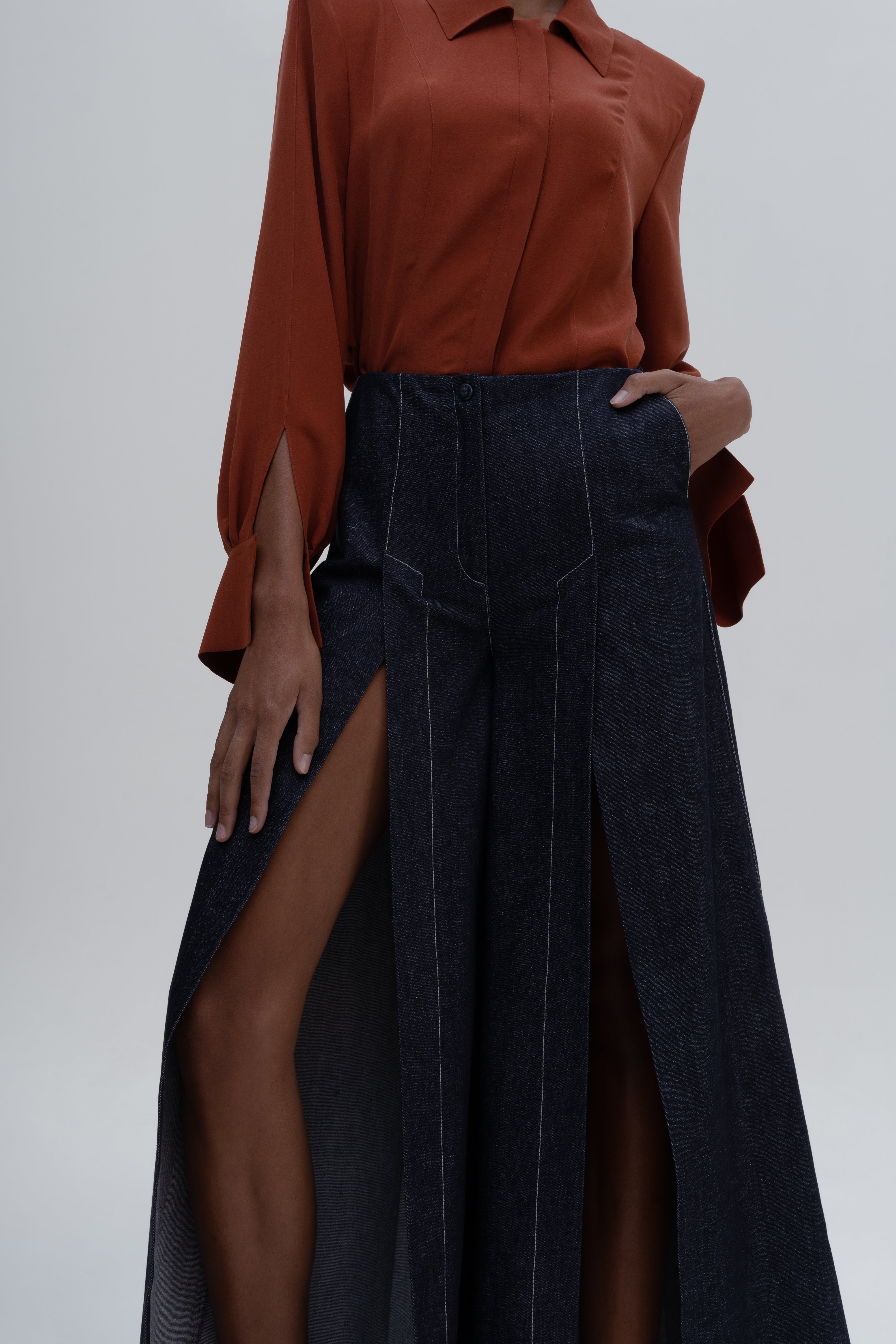 DENIM SLITS TROUSERS by Sagio from the Spring/Summer 2025 collection — wide-leg denim trousers featuring long vertical slits and a structured yet flowing silhouette. A bold, contemporary take on classic denim from thesagio.com