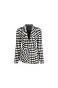 A women's long-sleeve blazer featuring a black and white houndstooth pattern, presented on a clean white background.