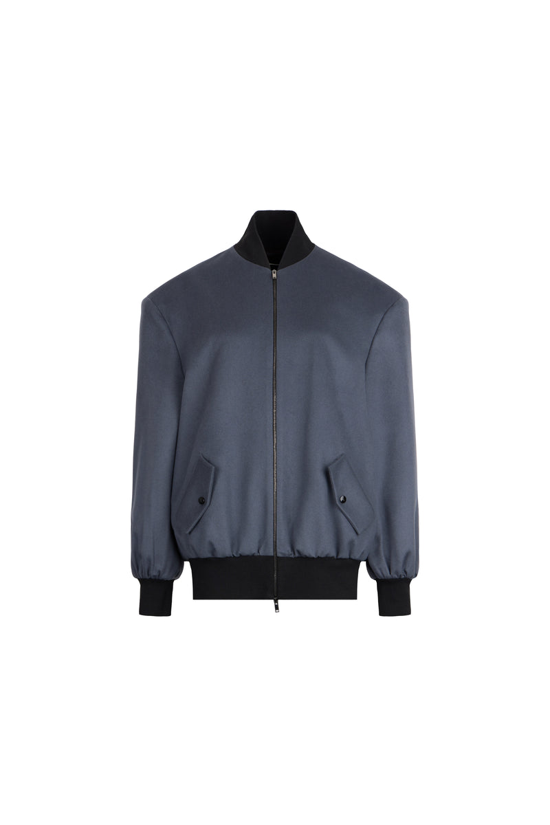A dark slate blue bomber jacket with black ribbed trim on the collar, cuffs, and hem, displayed against a solid white background.