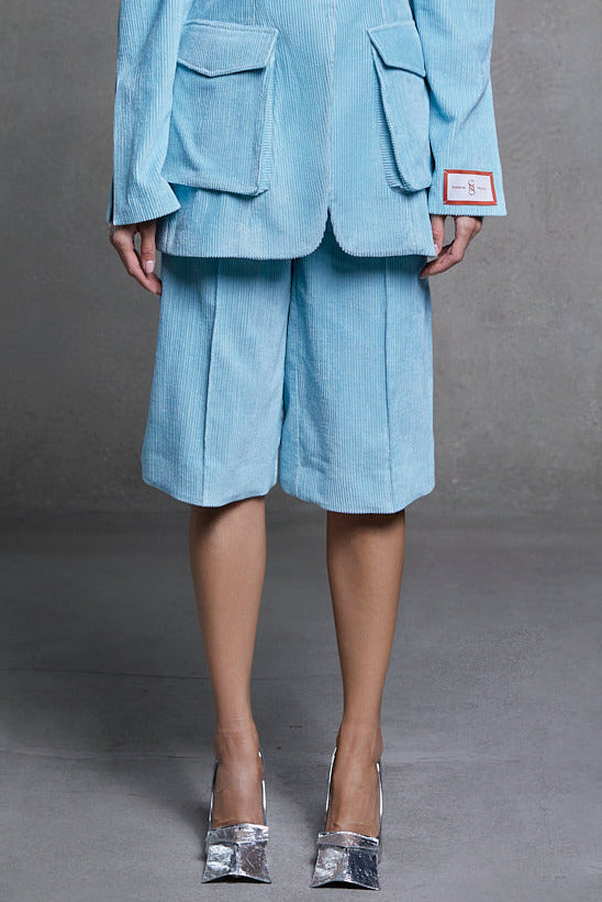 Azure velvet bermuda shorts and matching jacket, front view on model.