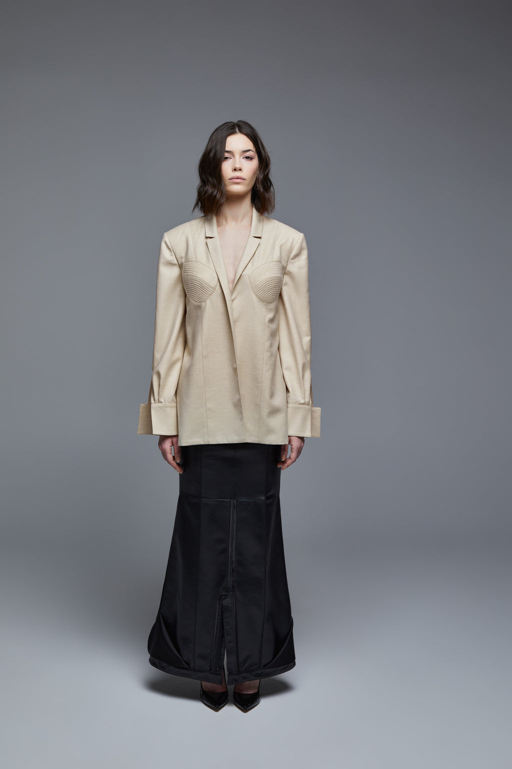 Beige wool designer shirt front view with sculpted bust seam detail on model