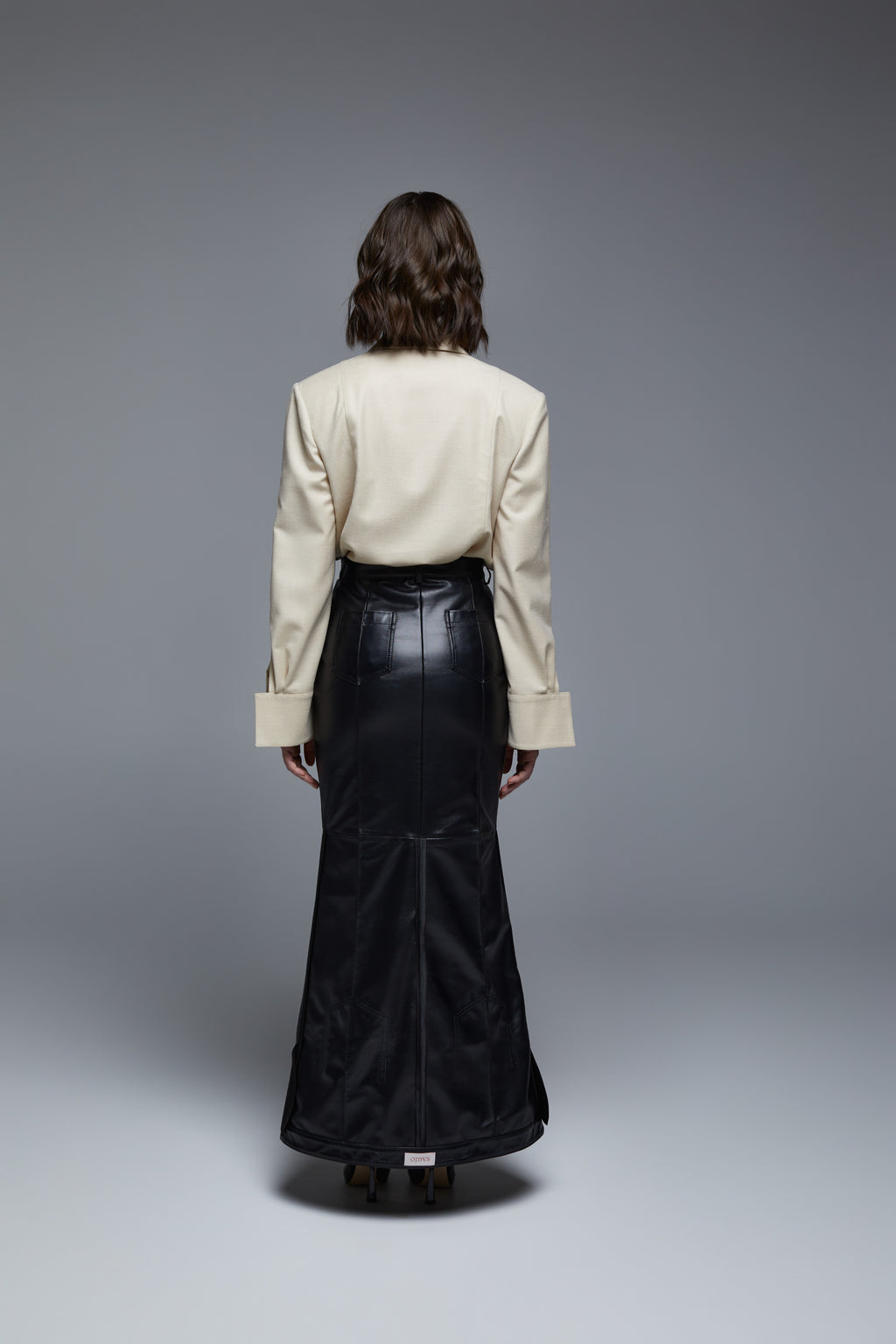 Black leather maxi skirt back view on model with high-waist silhouette