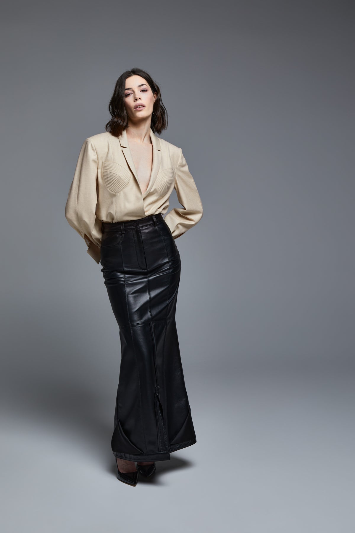 Black leather falling skirt front three-quarter view on model