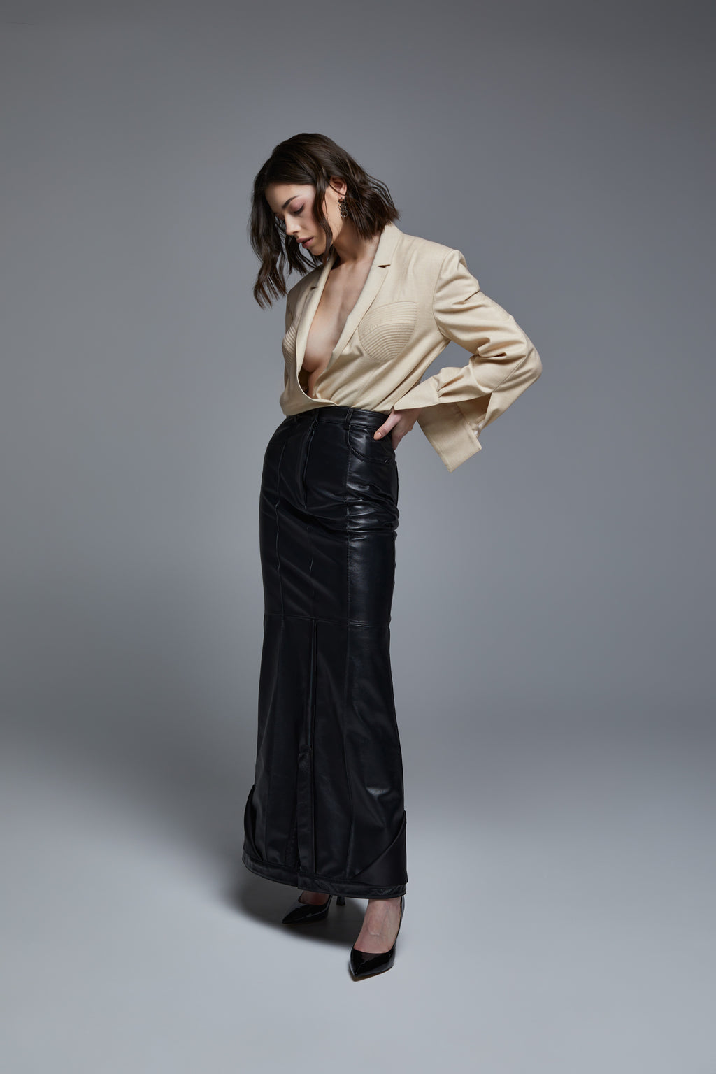 Black leather floor-length skirt side view on model with fitted silhouette
