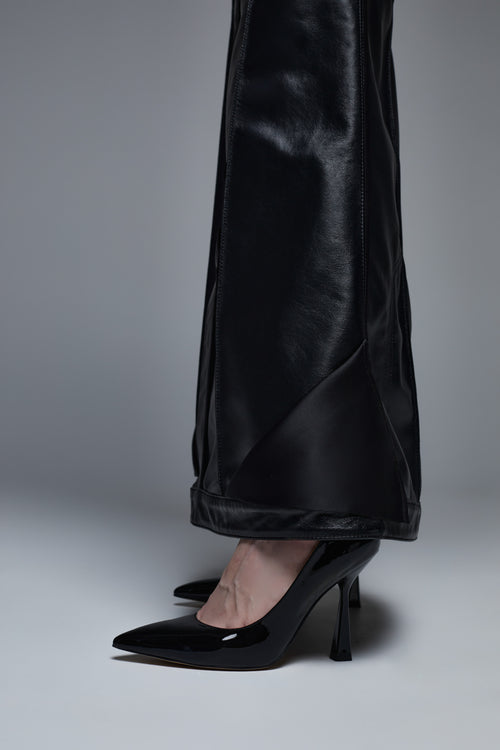 Black leather maxi skirt hem detail close-up with slight flared finish