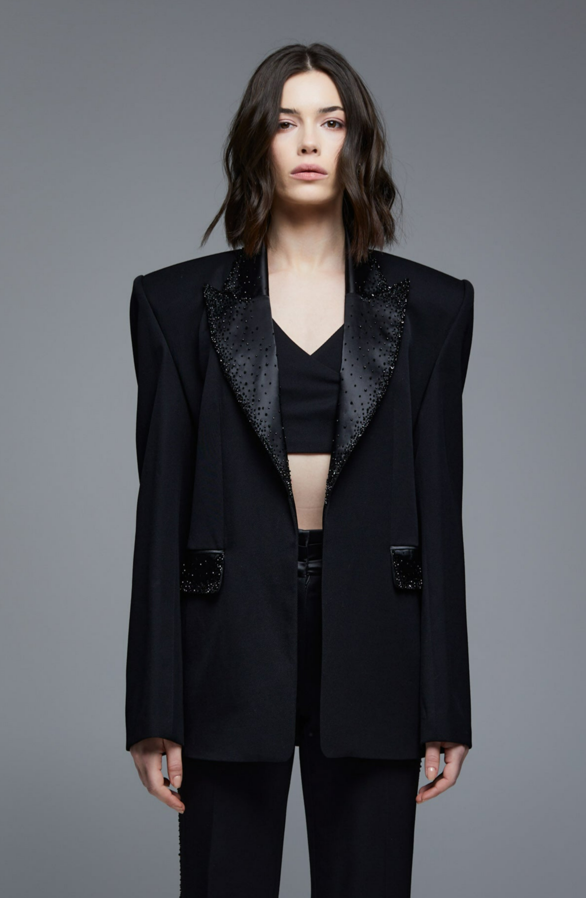 Black crystal embroidered tuxedo blazer front view on model with satin lapels