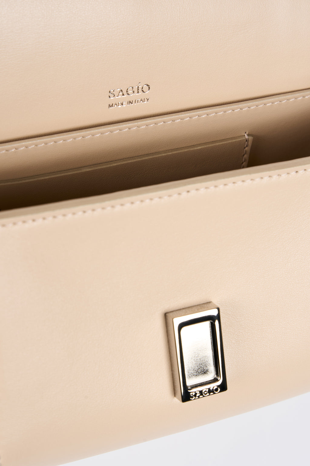 Beige Il Cupola bag interior detail with SAGIO logo stamp and silver-tone clasp