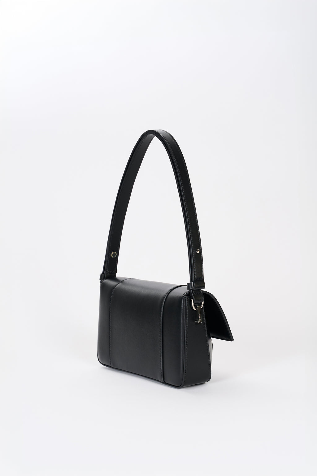 Black leather shoulder bag side view with structured silhouette and smooth lambskin finish