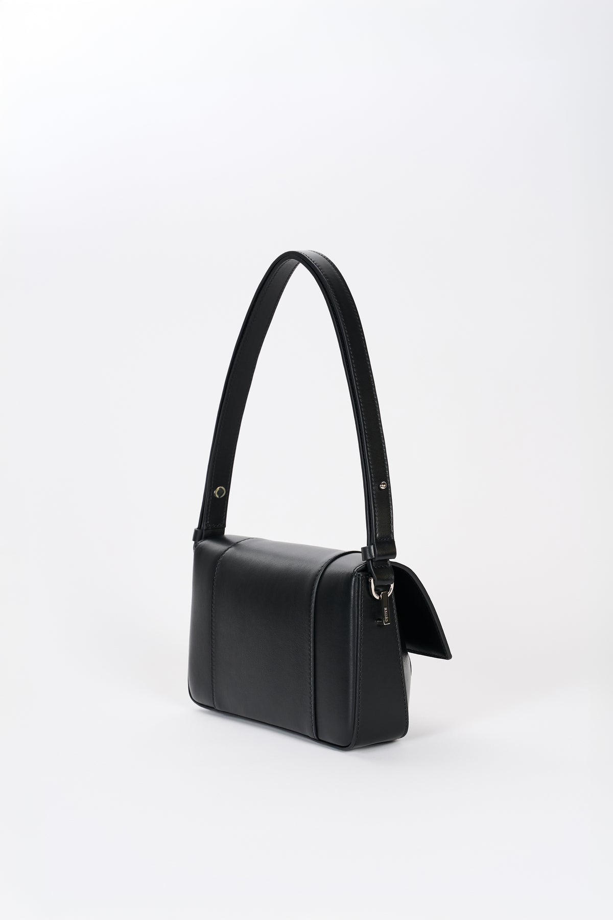 Black leather shoulder bag side view with structured silhouette and smooth lambskin finish
