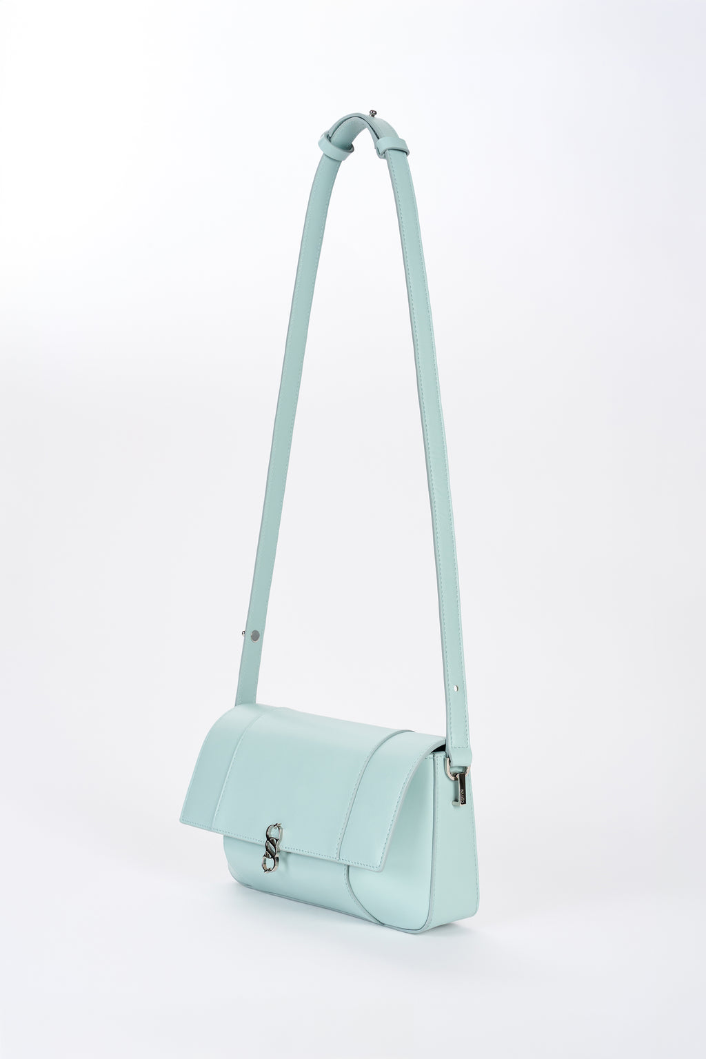 Clear aqua Il Cupola bag angled front view with elongated strap and curved flap