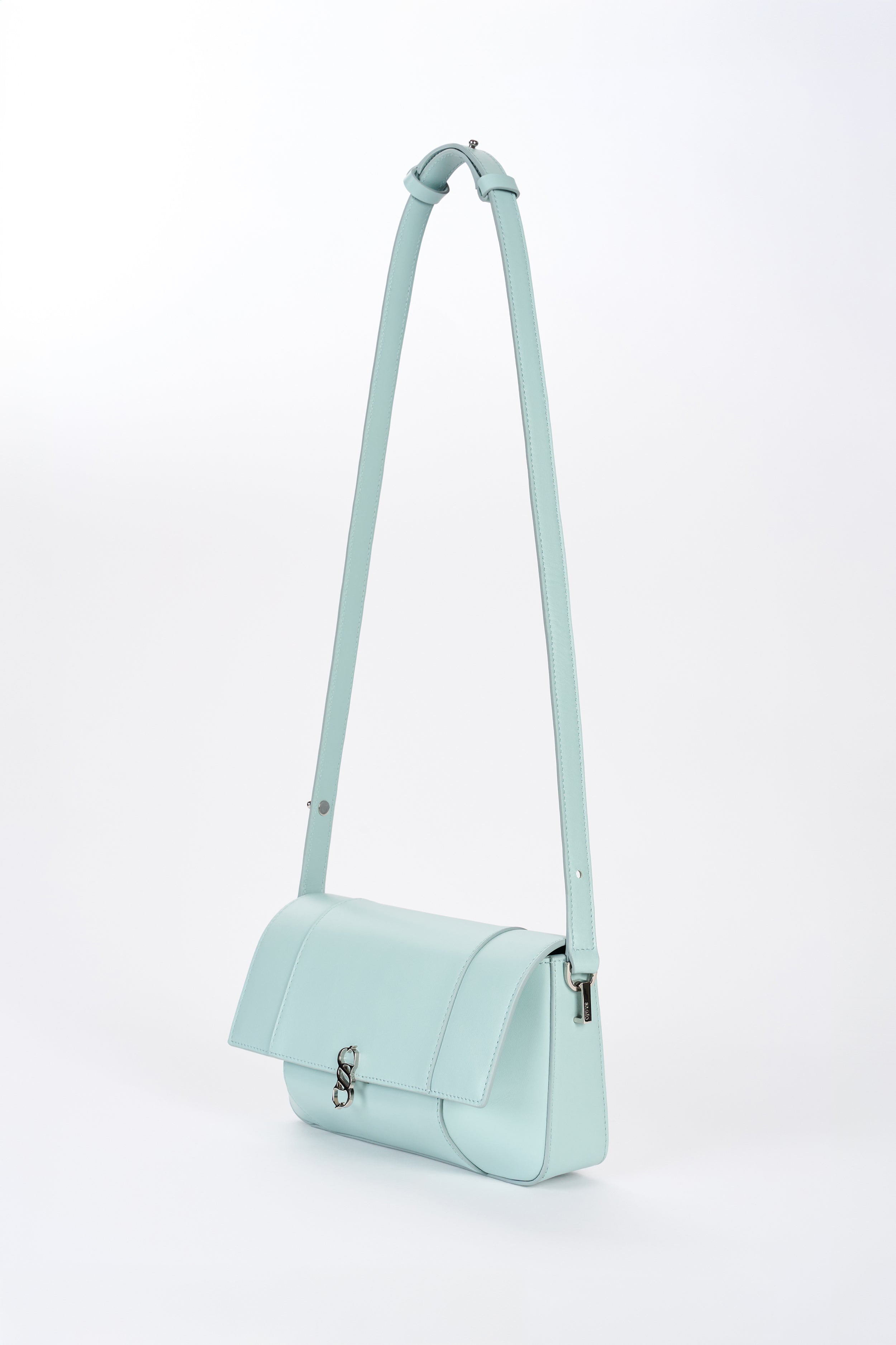 Clear aqua Il Cupola bag angled front view with elongated strap and curved flap