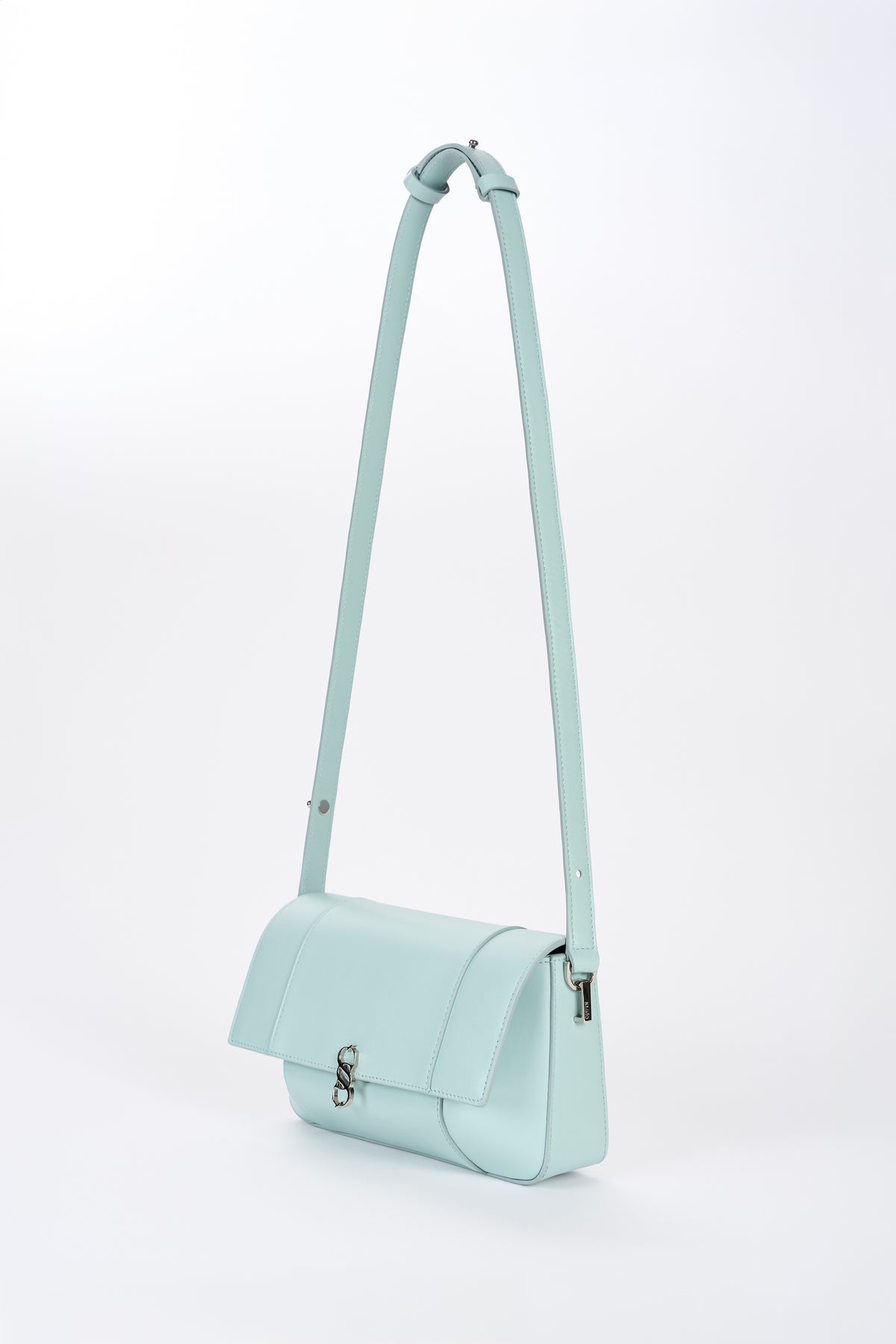 Clear aqua Il Cupola bag angled front view with elongated strap and curved flap