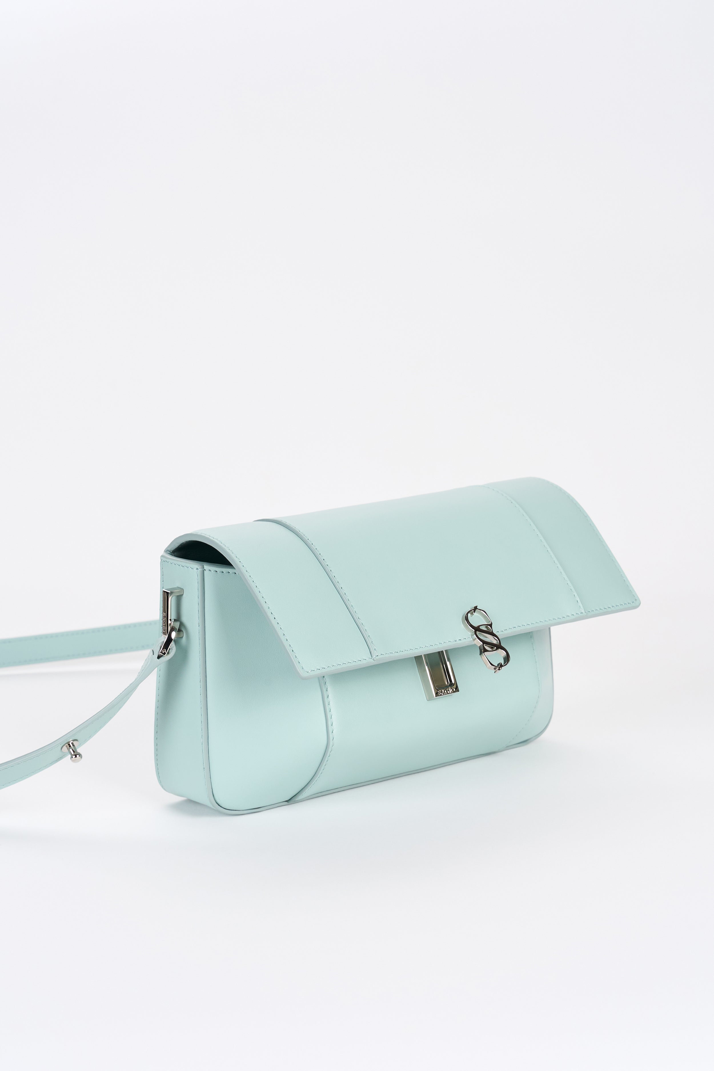 Clear aqua leather bag front view with structured shape and silver-tone logo detail