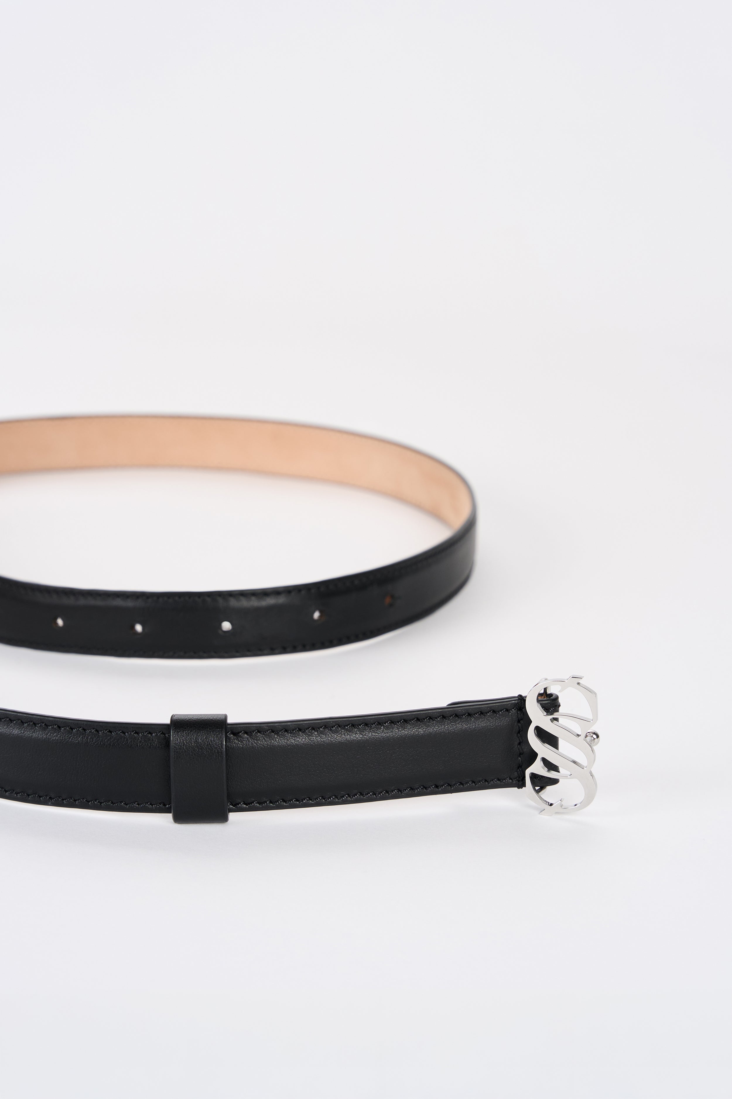 Black Italian calfskin belt with silver-tone SAGIO monogram buckle, detail view