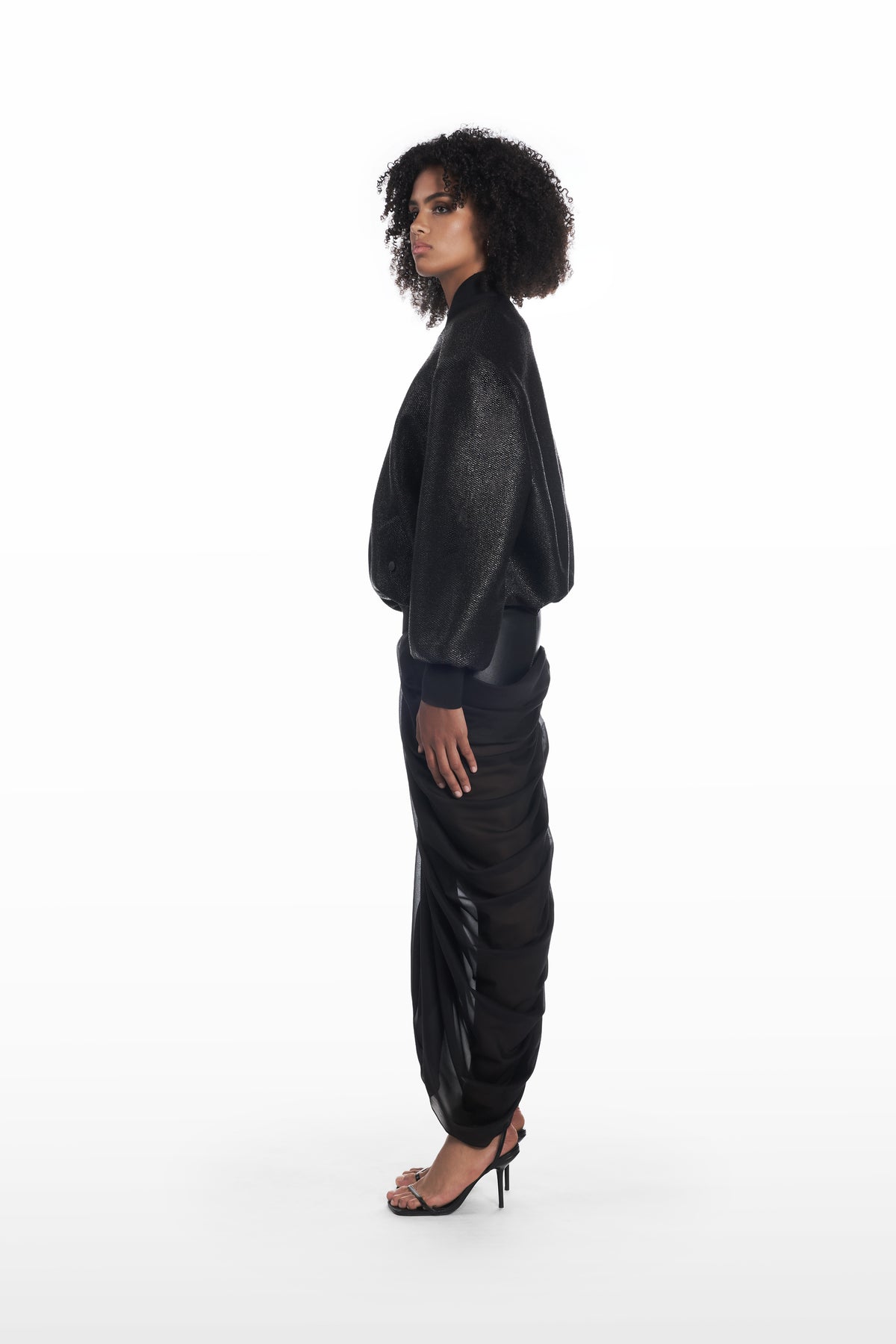 Oversize Raffia Bomber in black, side view with rounded volume and tactile raffia texture