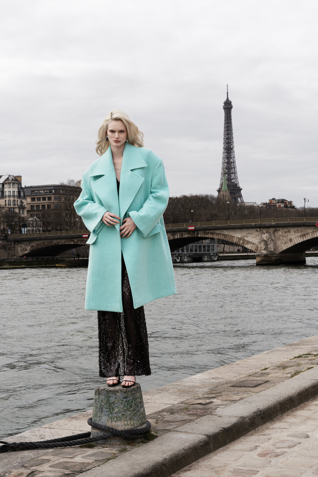 Woman in Falling Shoulder Coat, Beach Glass color; oversized wool coat with wide lapels