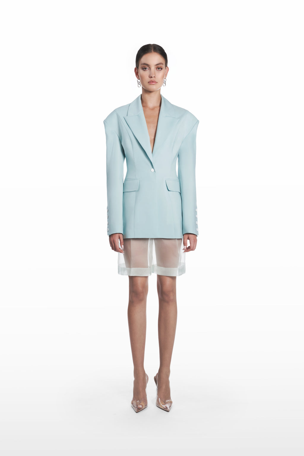 Transparent silk bermuda shorts in clear aqua, front view with sheer finish styled under a matching blazer