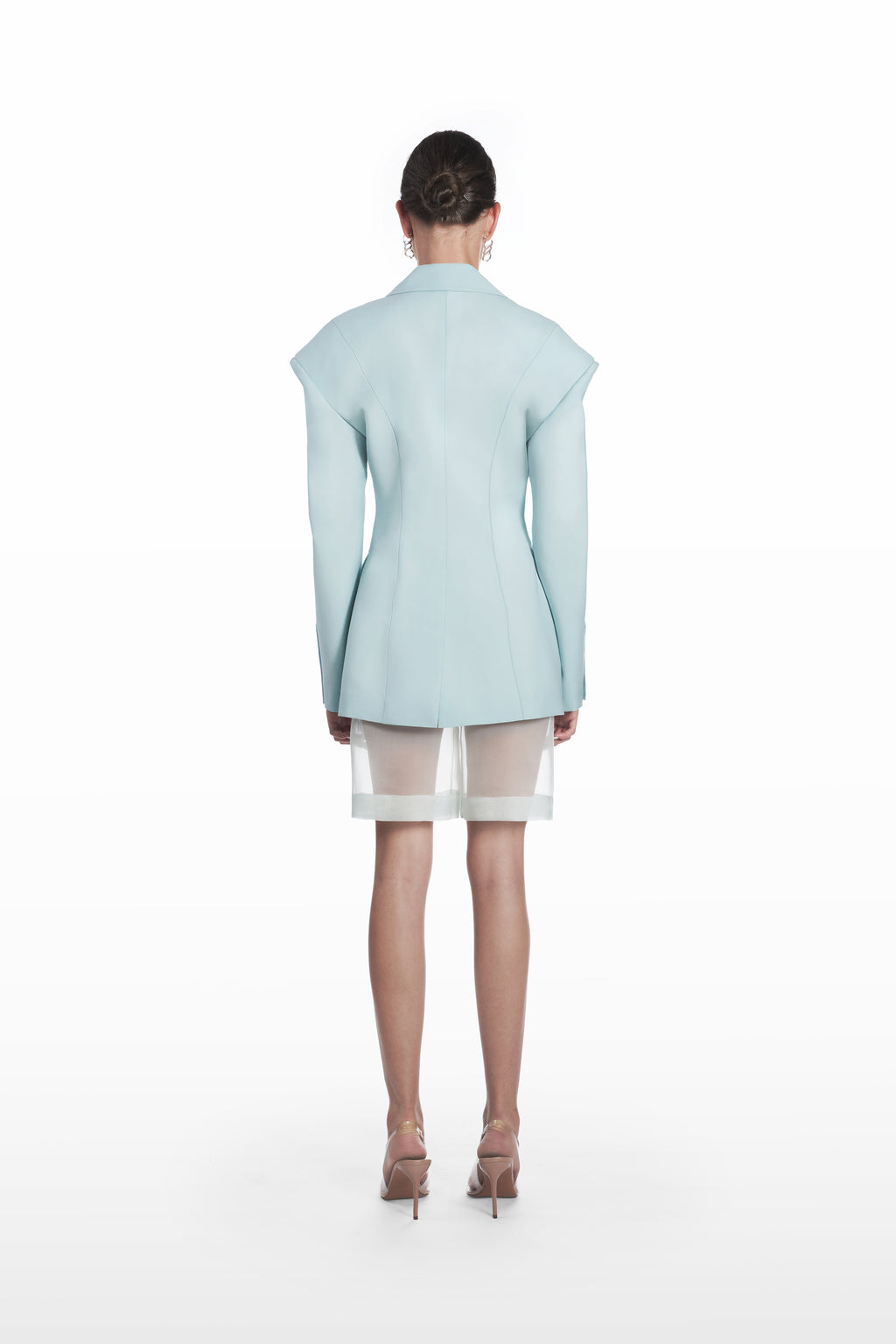 Transparent silk bermuda shorts in clear aqua, back view with sheer construction and clean tailored line