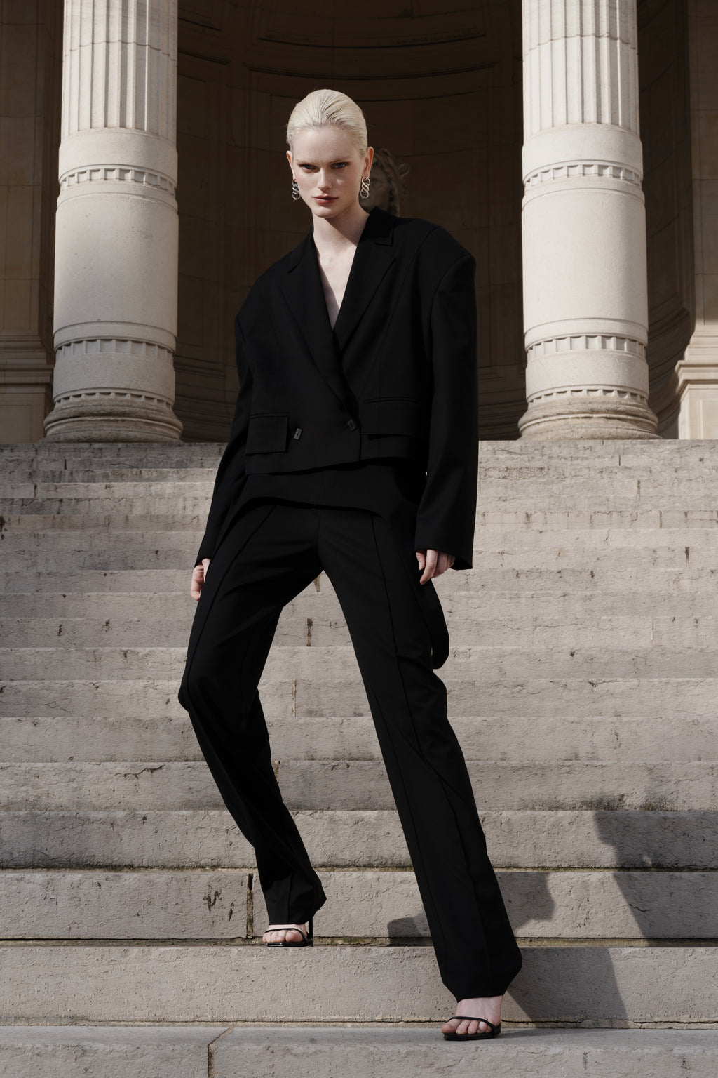 Women’s black wool cropped blazer with falling-shoulder design and sharp lapel