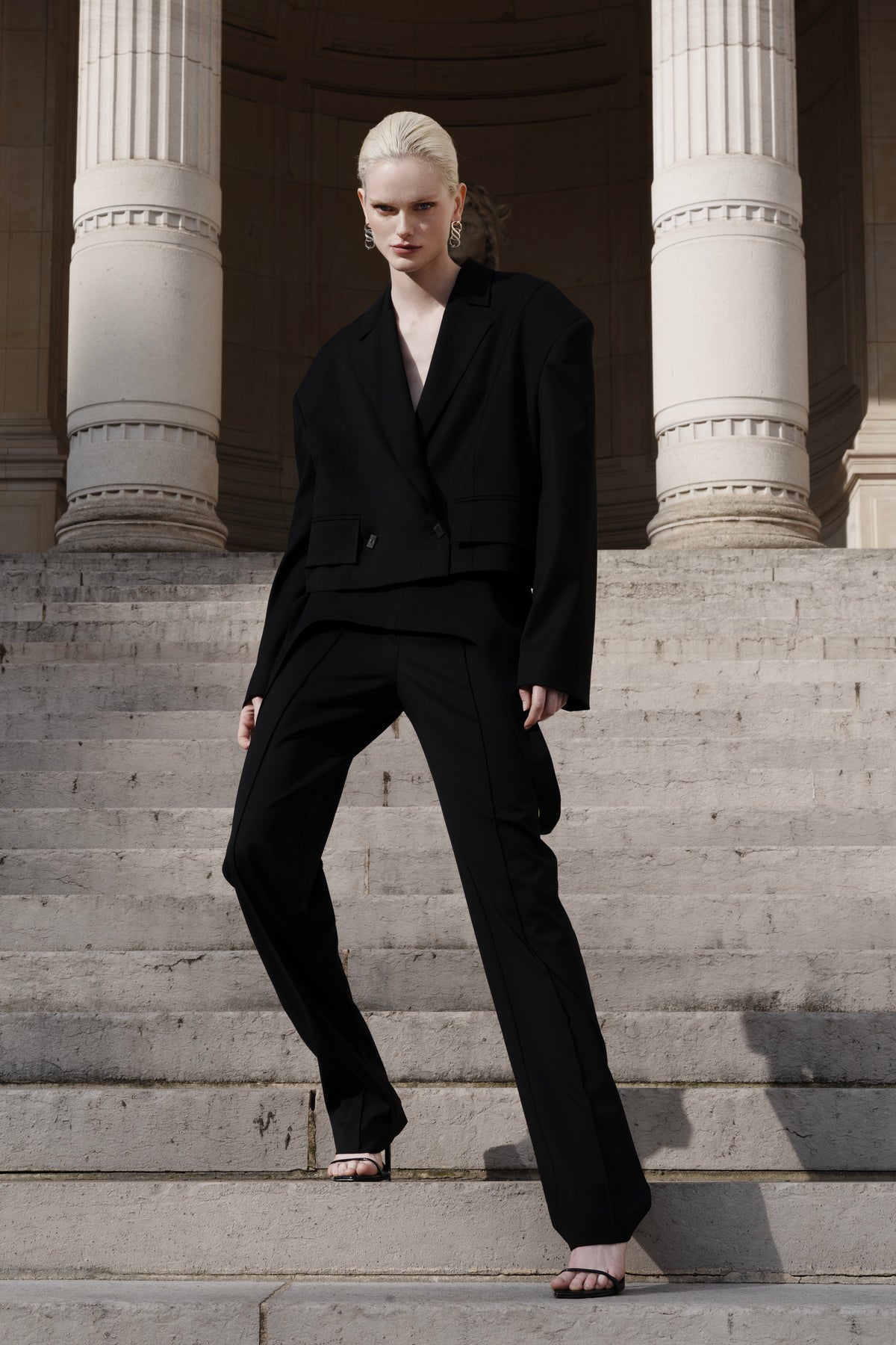 Women’s black wool cropped blazer with falling-shoulder design and sharp lapel