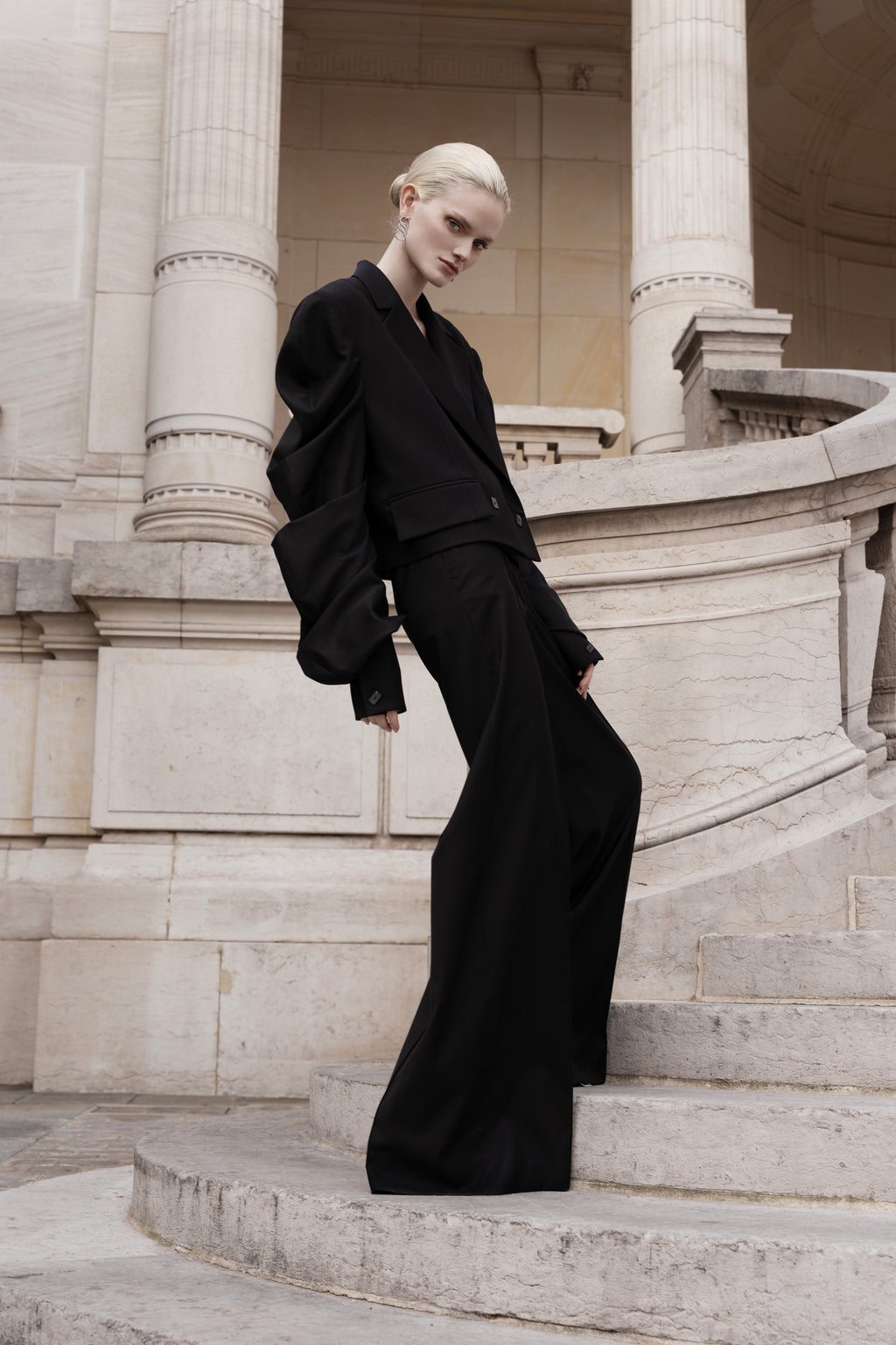 Women’s black silk trench coat with tie belt and wide lapels, longline silhouette