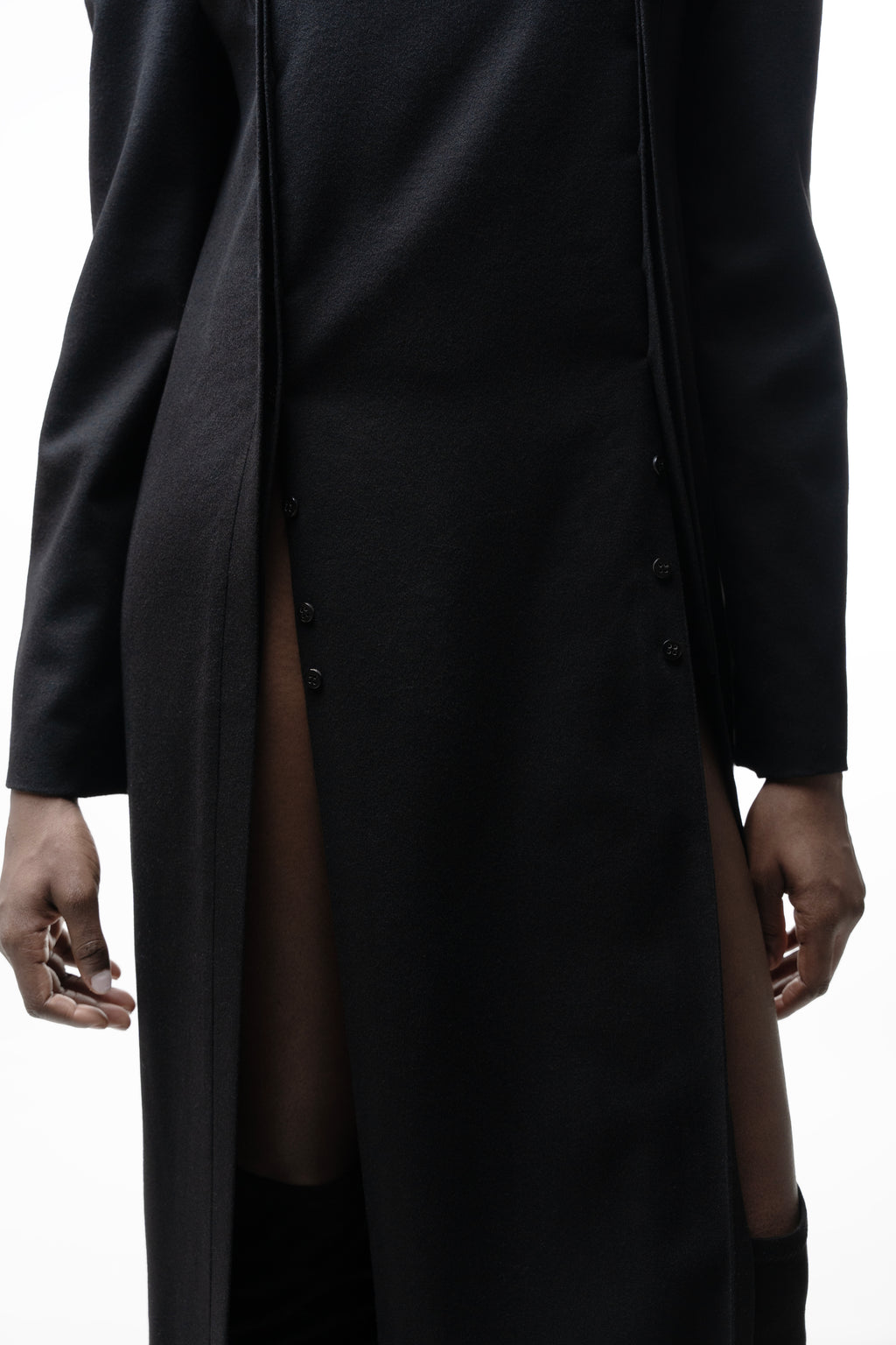 Long Placket Dress in Black on model, front view with open placket and high side slits.