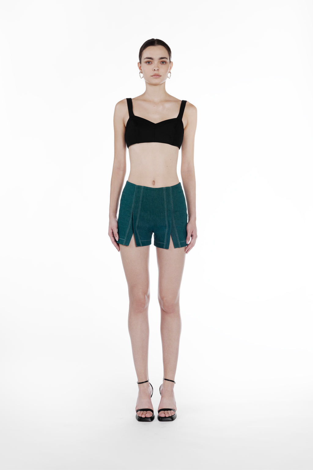 Mini Slits Shorts in Emerald Green, front view, tailored cotton mini shorts with front slit detailing, contrast topstitching and sculptural fit