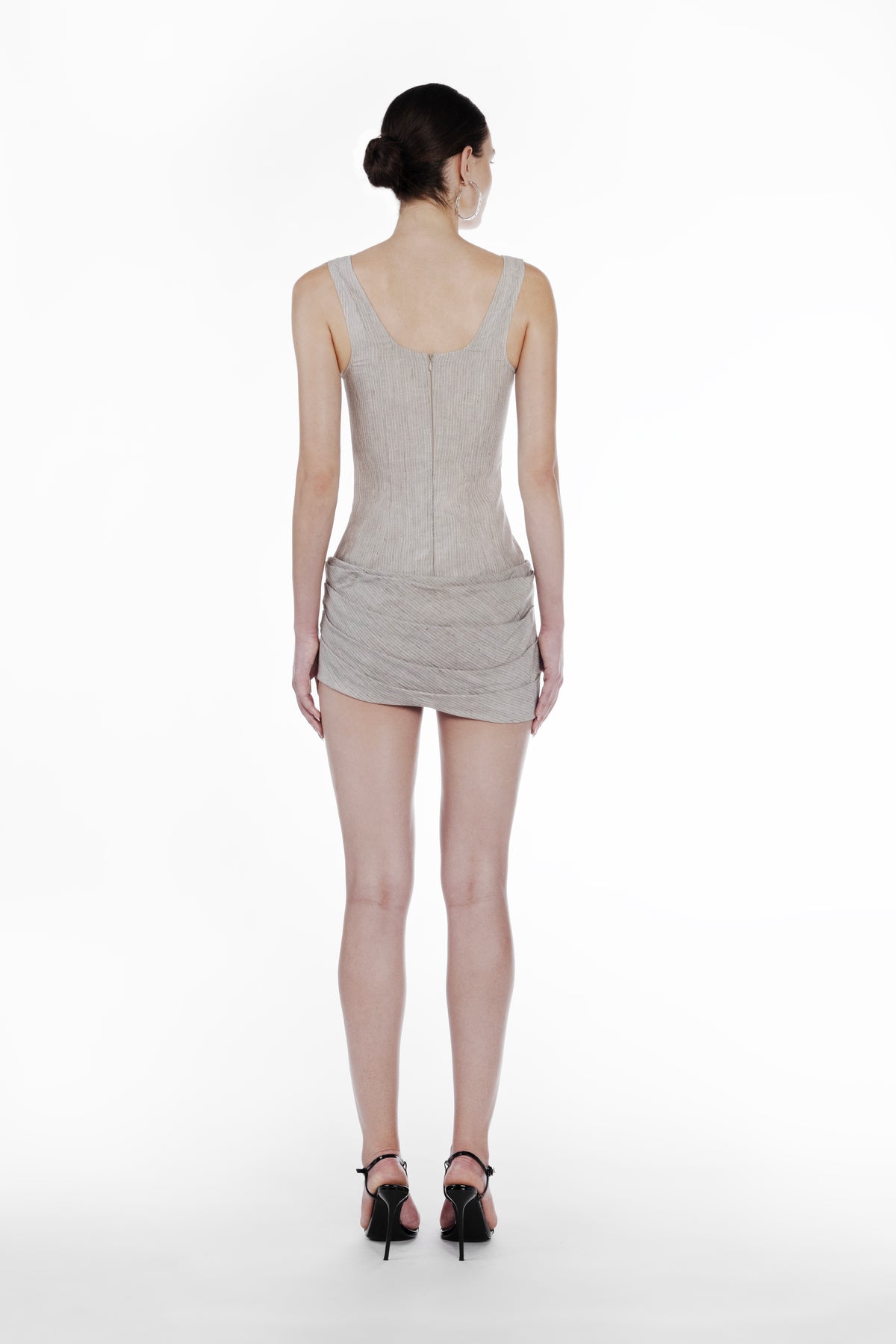 Linen Stripes Bodydress in cold beige, back view of the sleeveless striped mini dress with fitted silhouette and draped skirt detail