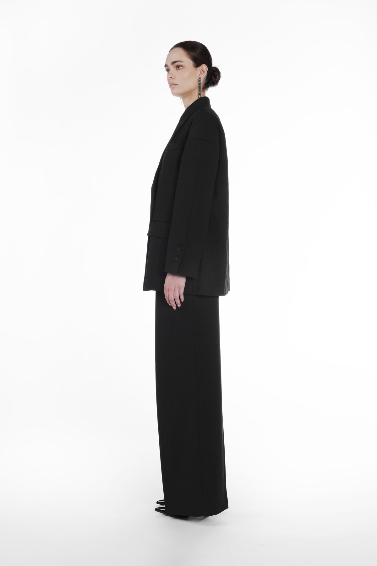 Falling Shoulder Double-Breasted Jacket black side view with elongated fit and structured virgin wool silhouette