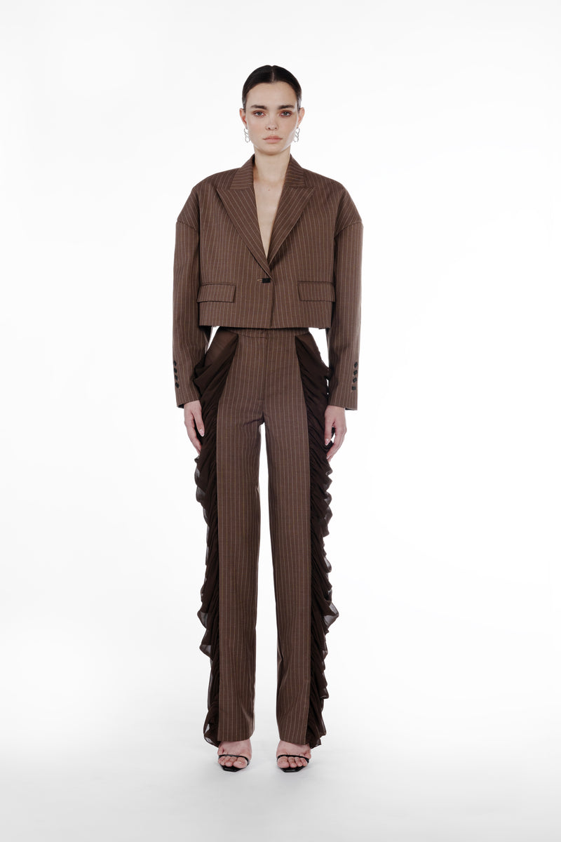 Silk Folds Stripes Trousers in Brown, front view, pinstriped tailored trousers with side silk folds, straight leg silhouette and sculptural contrast panels. Falling Shoulders Stripes Jacket by SAGIO in brown beige pinstripe wool, front view, cropped tailored jacket with sheer draped side panels