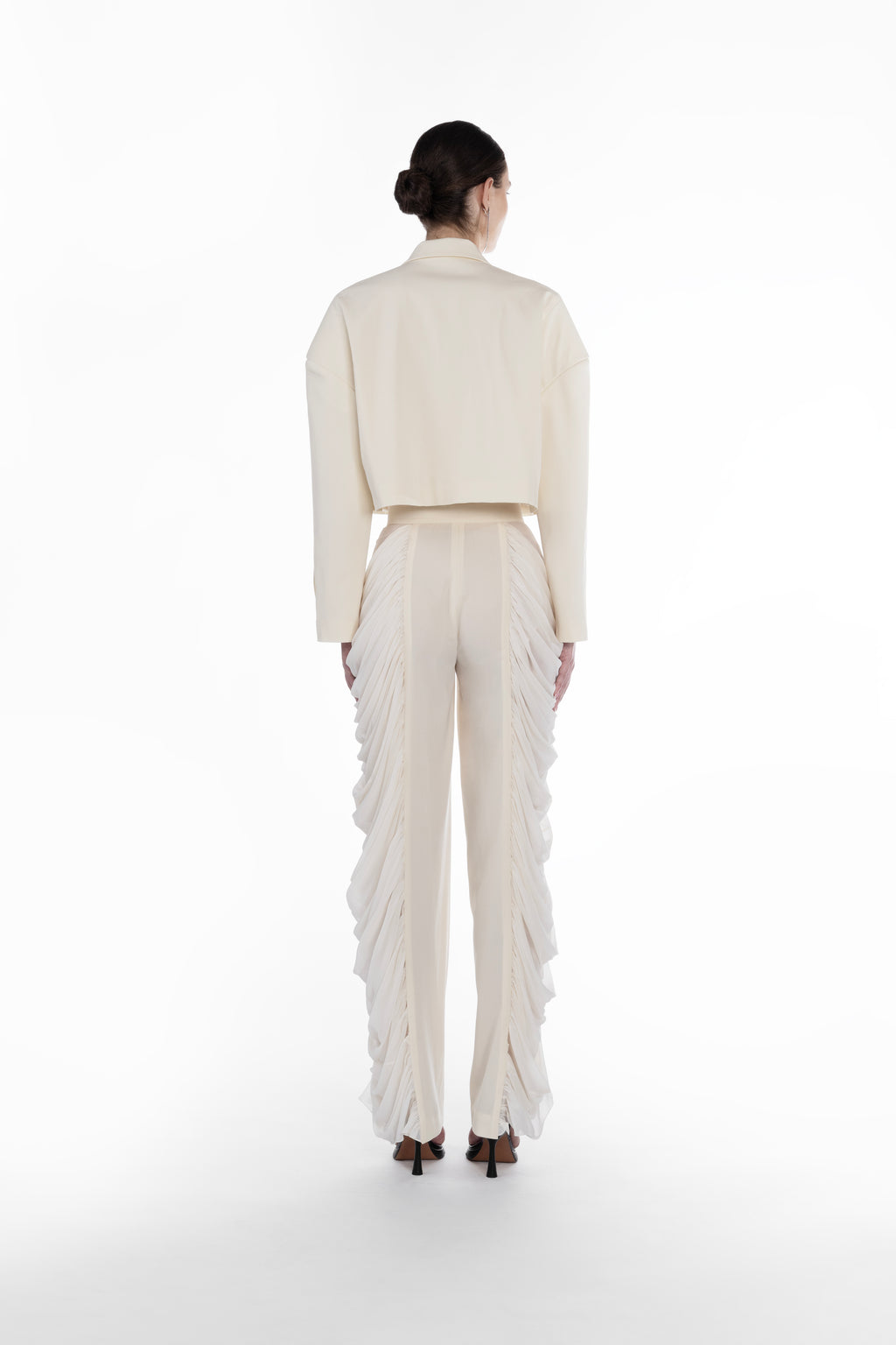 Silk Folds Trousers in Ivory, back view, designer silk-wool trousers with clean tailored back and dramatic folded side panels and Falling Shoulders Jacket in light neutral virgin wool, close-up front detail with lapels, cropped cut and tailored finish