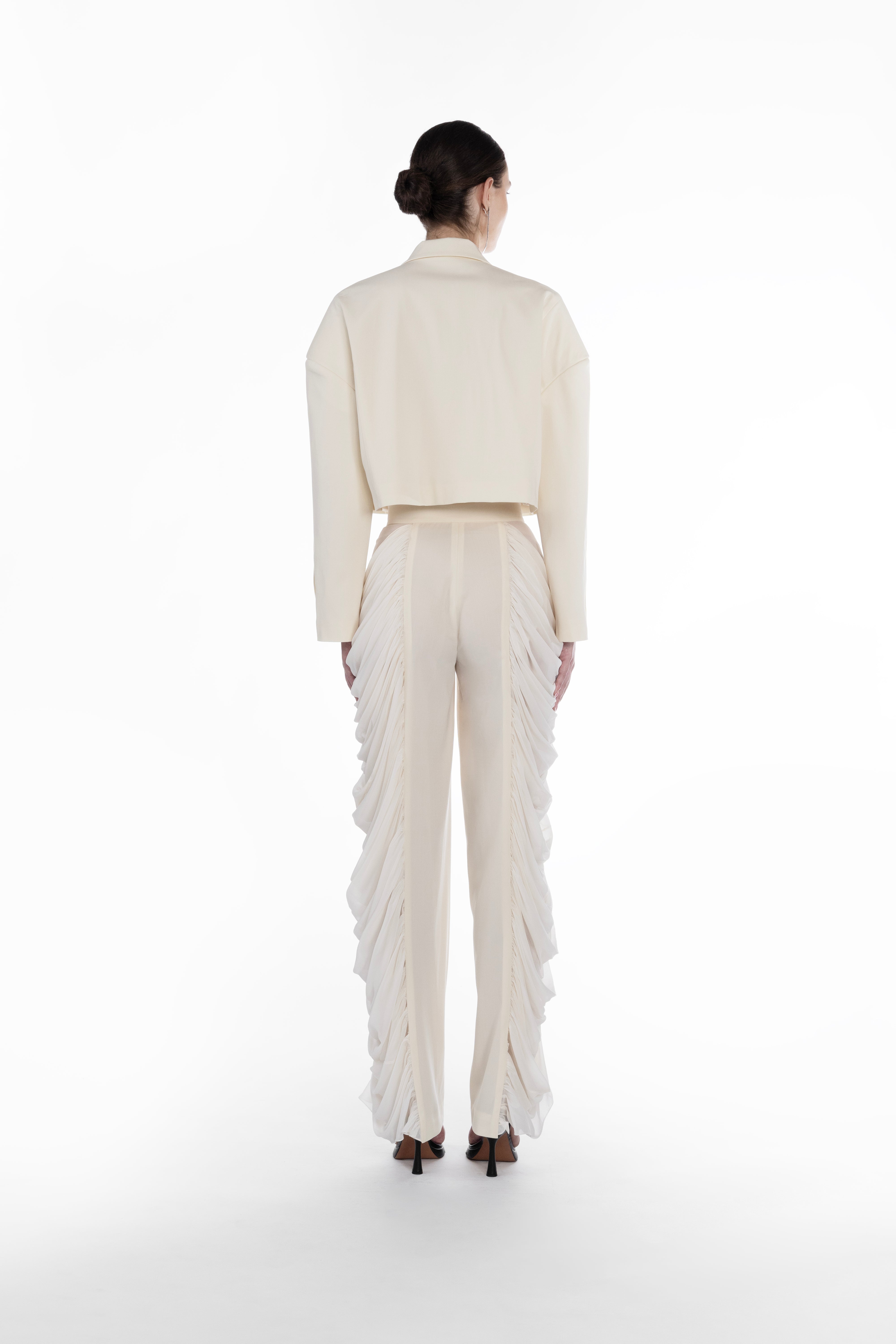 Silk Folds Trousers in Ivory, back view, designer silk-wool trousers with clean tailored back and dramatic folded side panels and Falling Shoulders Jacket in light neutral virgin wool, close-up front detail with lapels, cropped cut and tailored finish