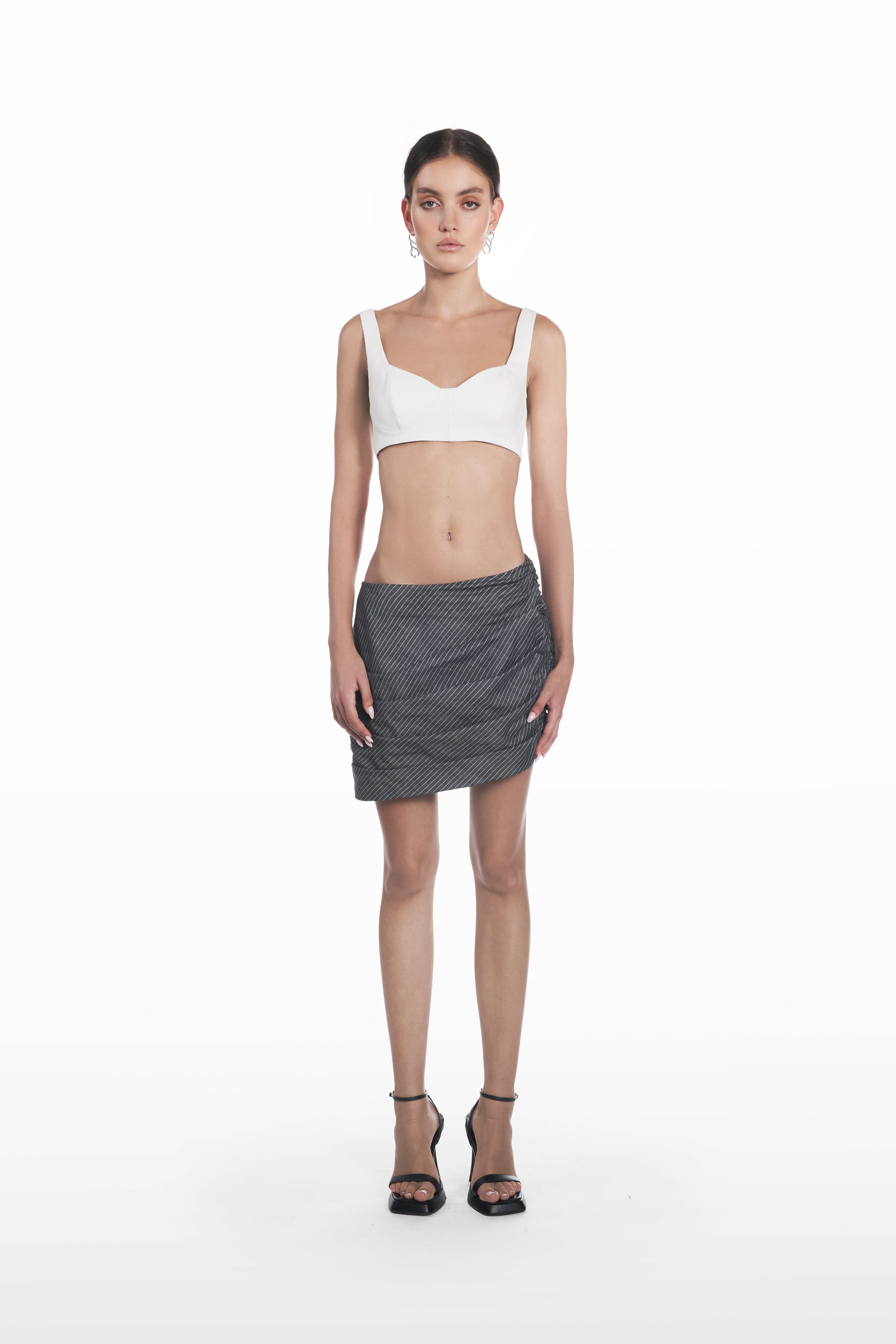 Falling Palla Stripes Skirt in dark grey pinstripe, front view, asymmetric low-rise mini silhouette