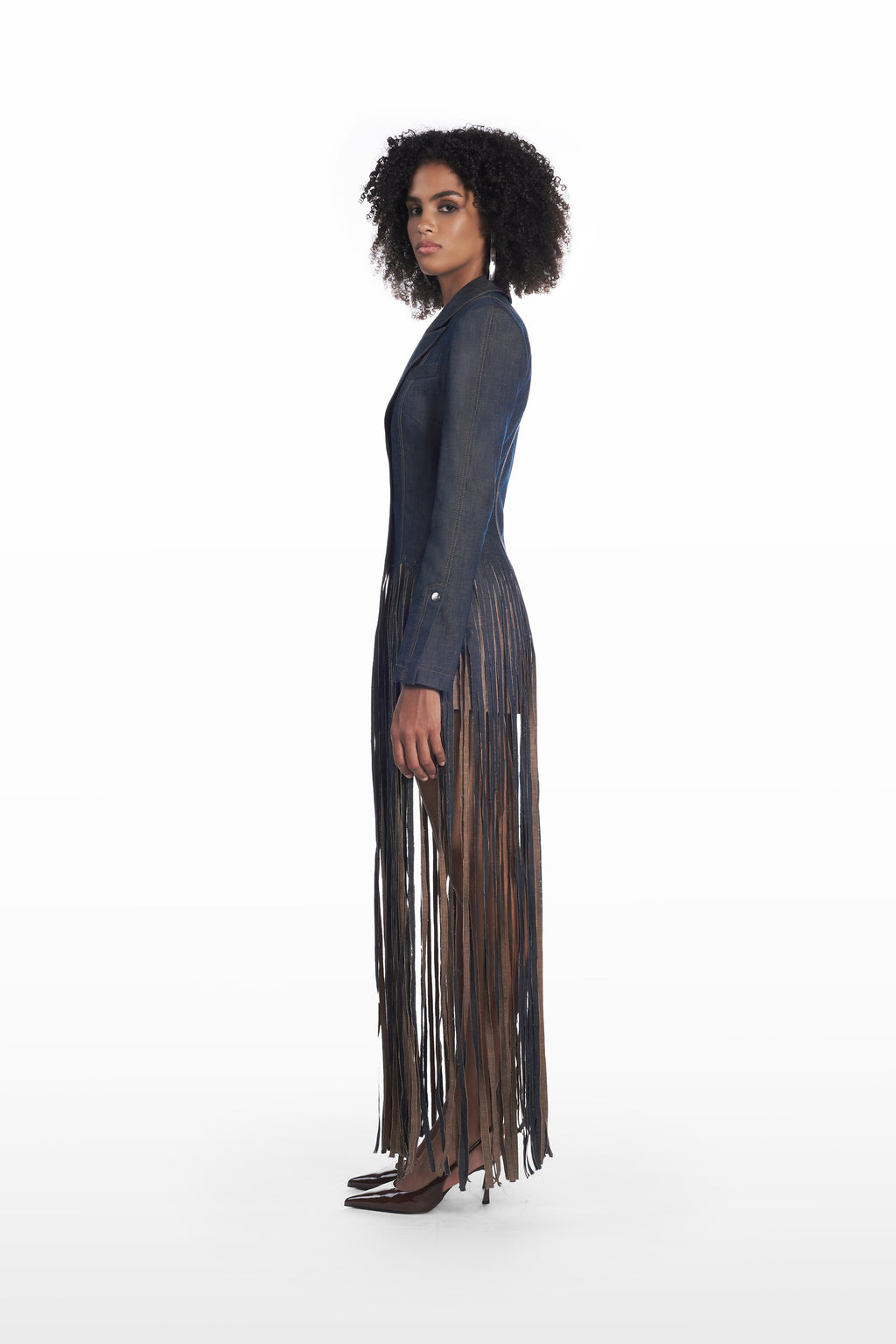 Fringe denim coat in dark indigo, side view with elongated fringe detailing and tailored silhouette