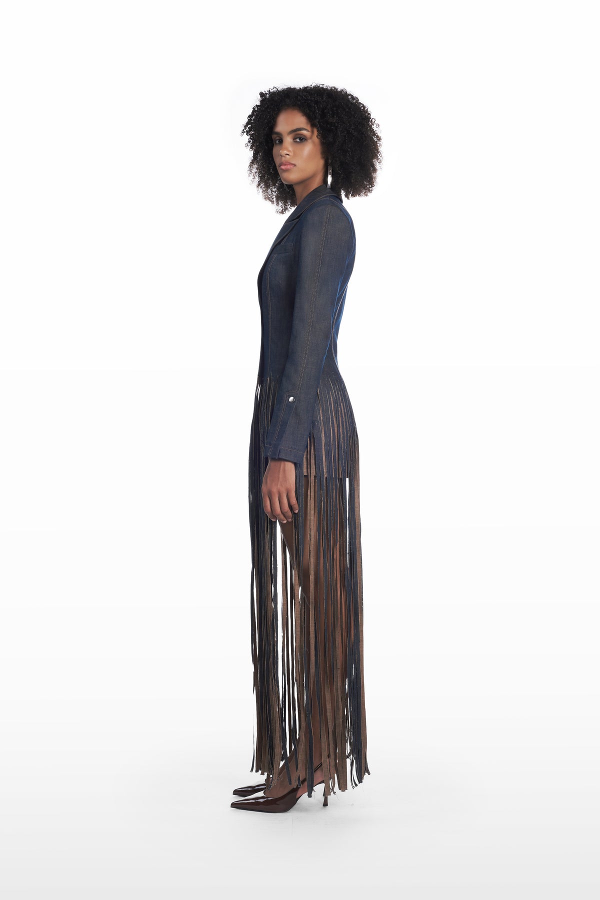 Fringe denim coat in dark indigo, side view with elongated fringe detailing and tailored silhouette