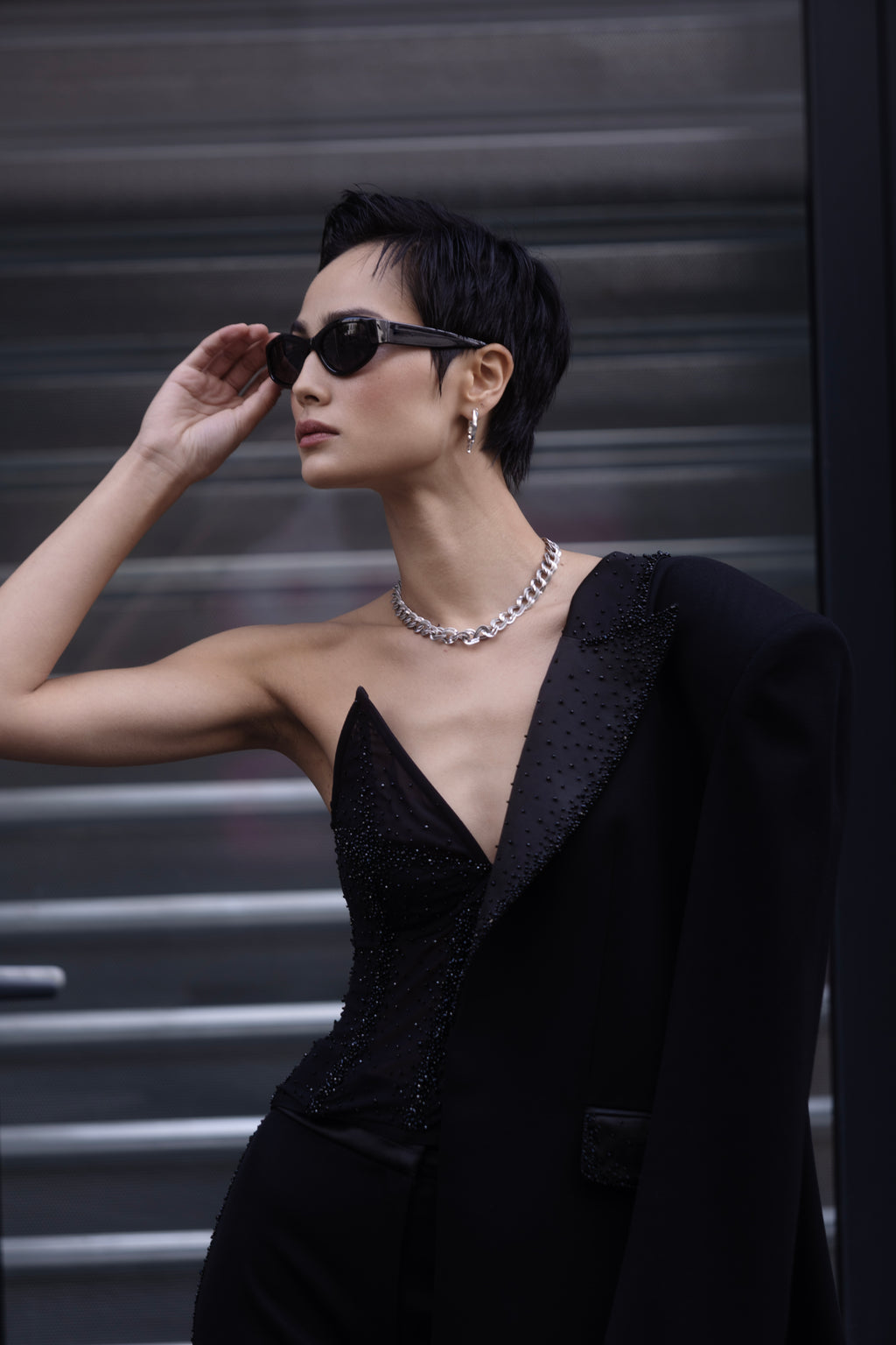 Black crystal embroidered tuxedo layered over eveningwear close-up on model