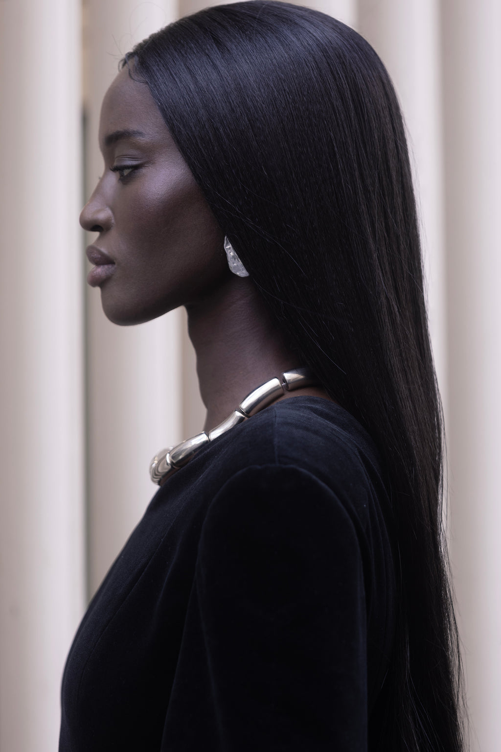 Neckline and shoulder of black asymmetrical dress