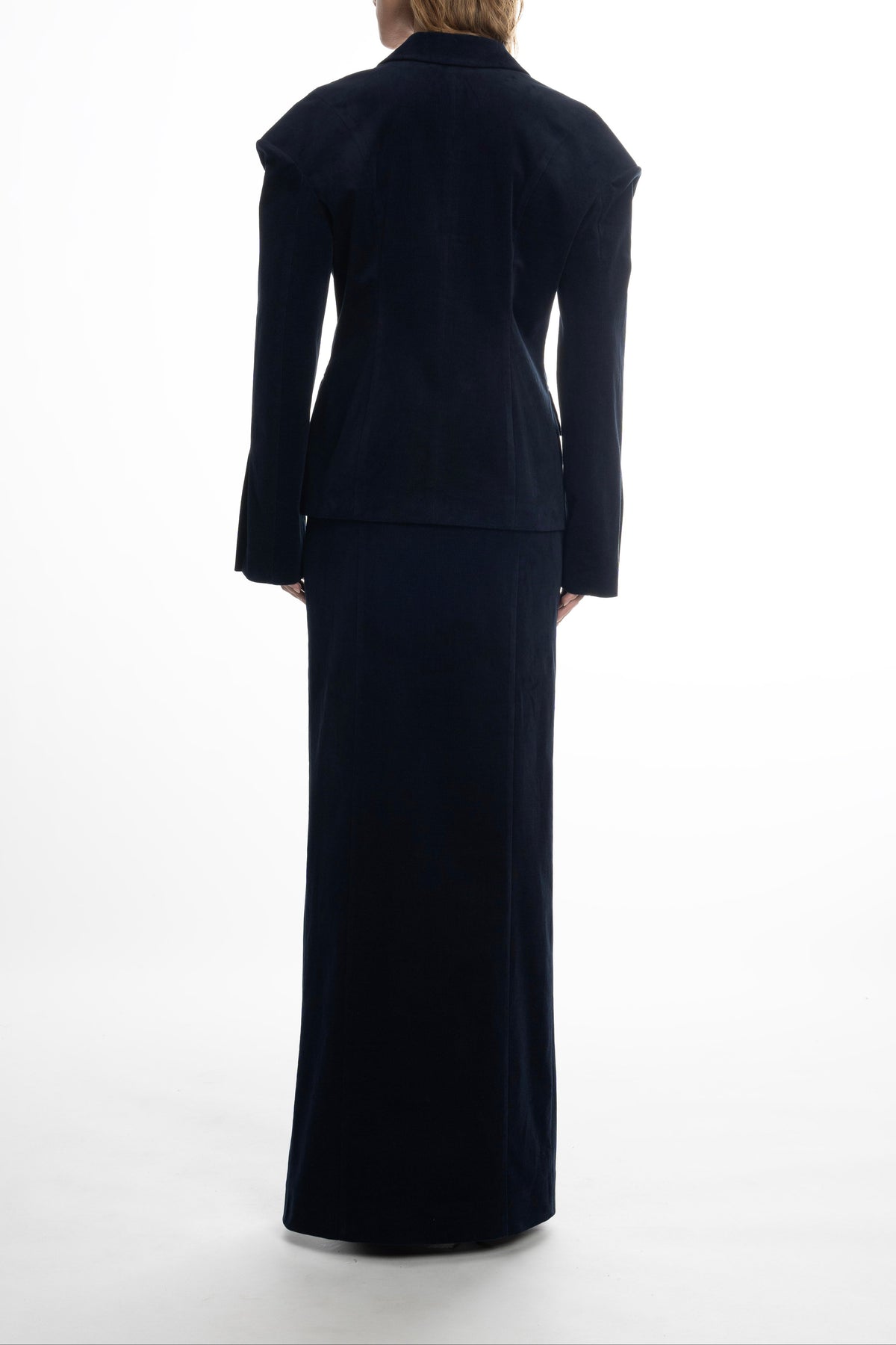 Woman wearing a navy blue suit, long cotton maxi skirt in navy with smooth seams. 