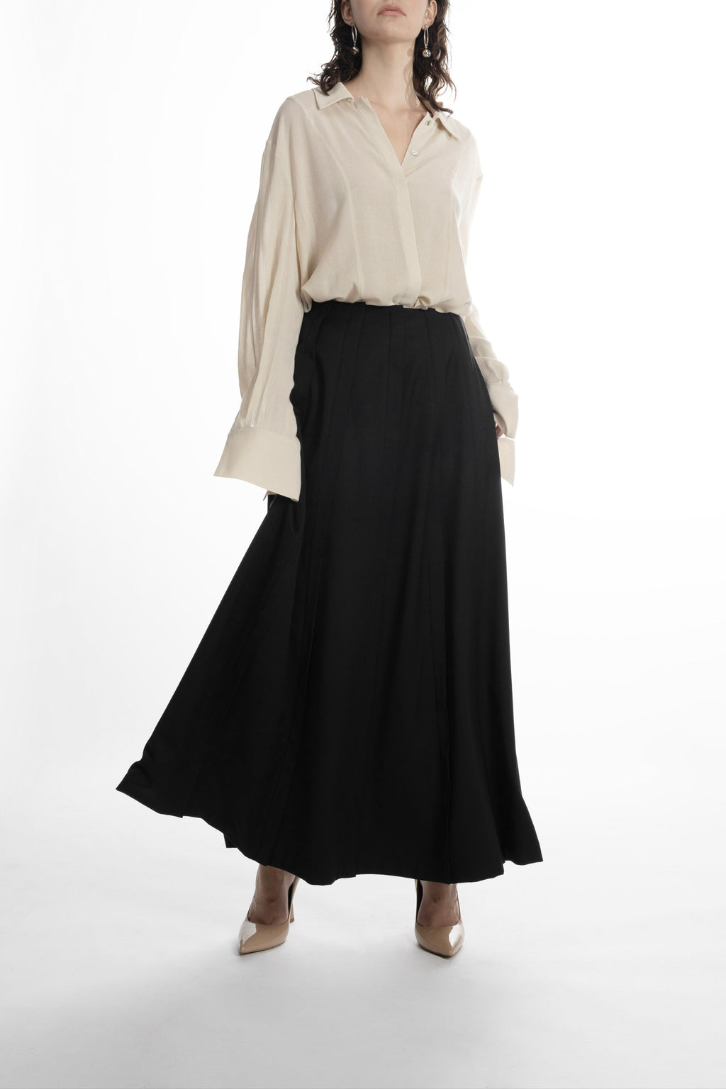 Women’s black wool maxi skirt, flowing movement, architectural pleats