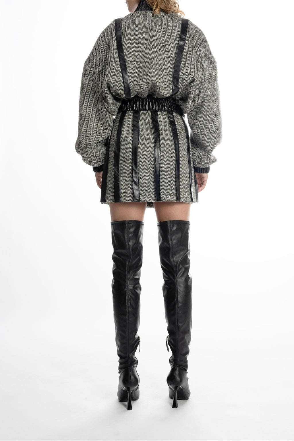 Women’s grey tweed mini skirt with leather placket stripes, back view on model