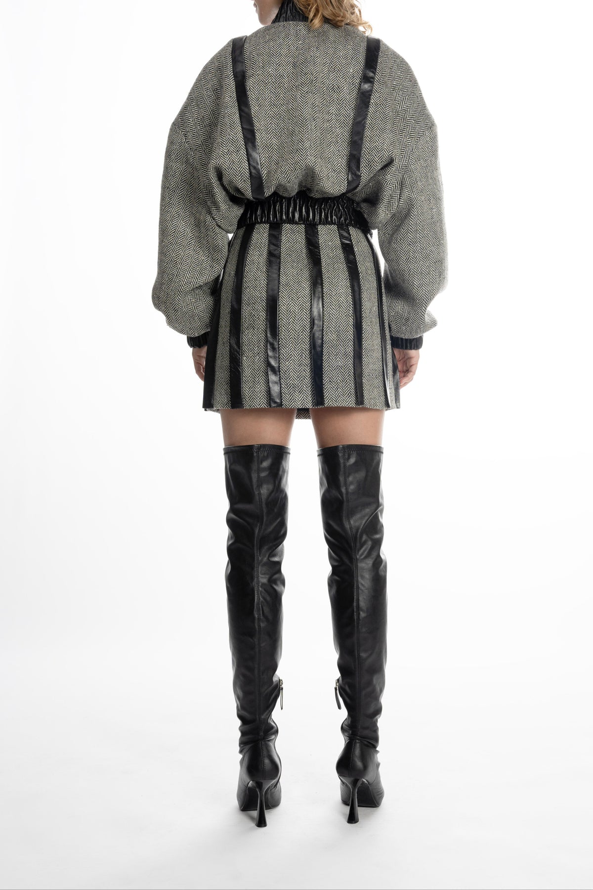 Women’s grey tweed mini skirt with leather placket stripes, back view on model