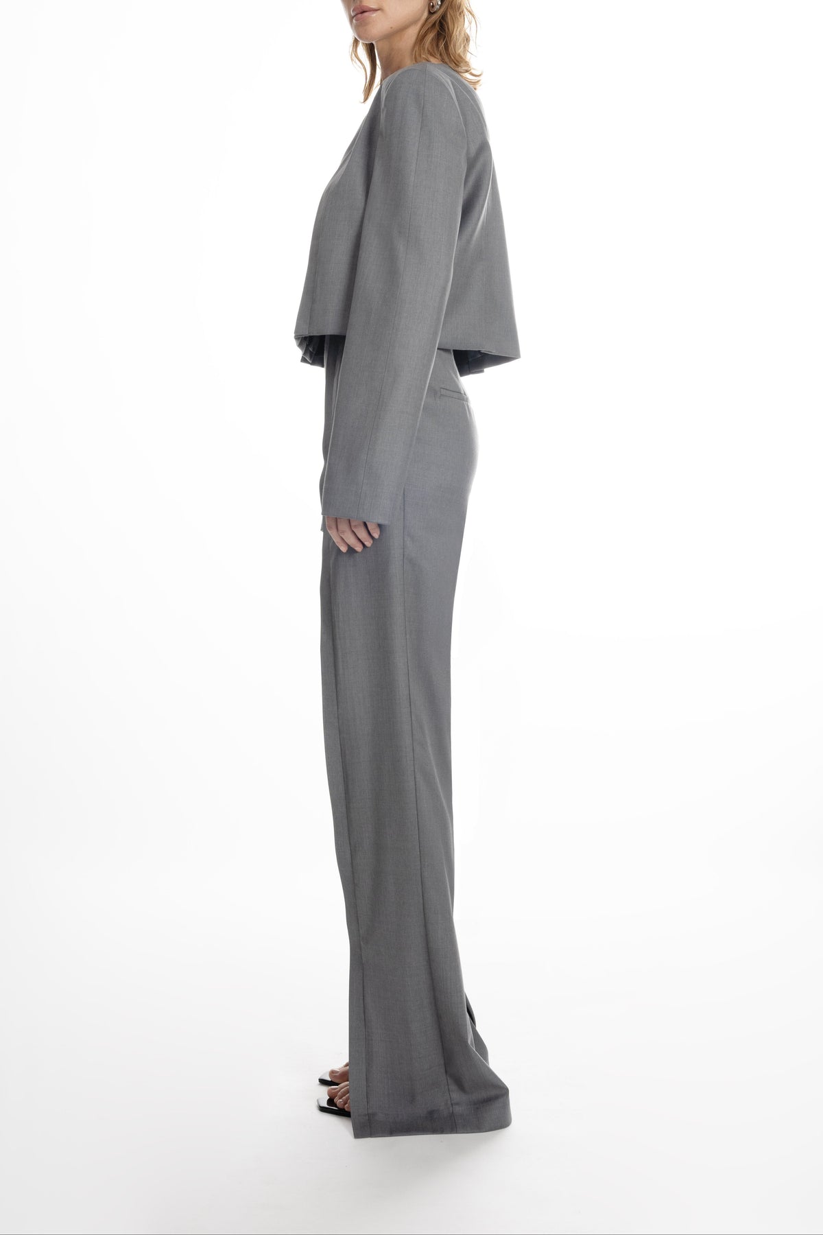 Open Shoulder Short Jacket in light grey, clean profile and cropped length, styled with matching trousers