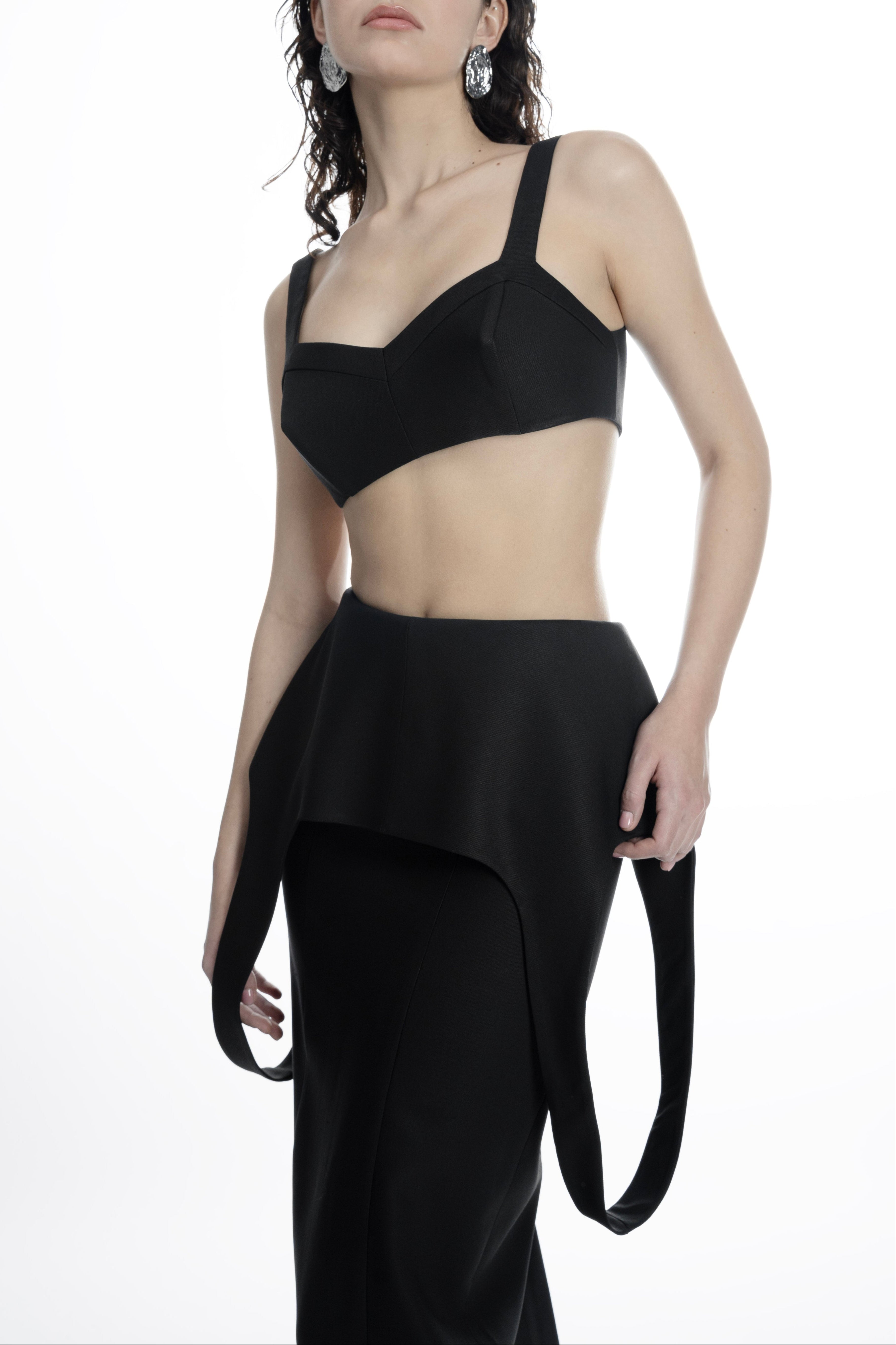 Sculptural peplum hip detail on black wool-blend maxi skirt.