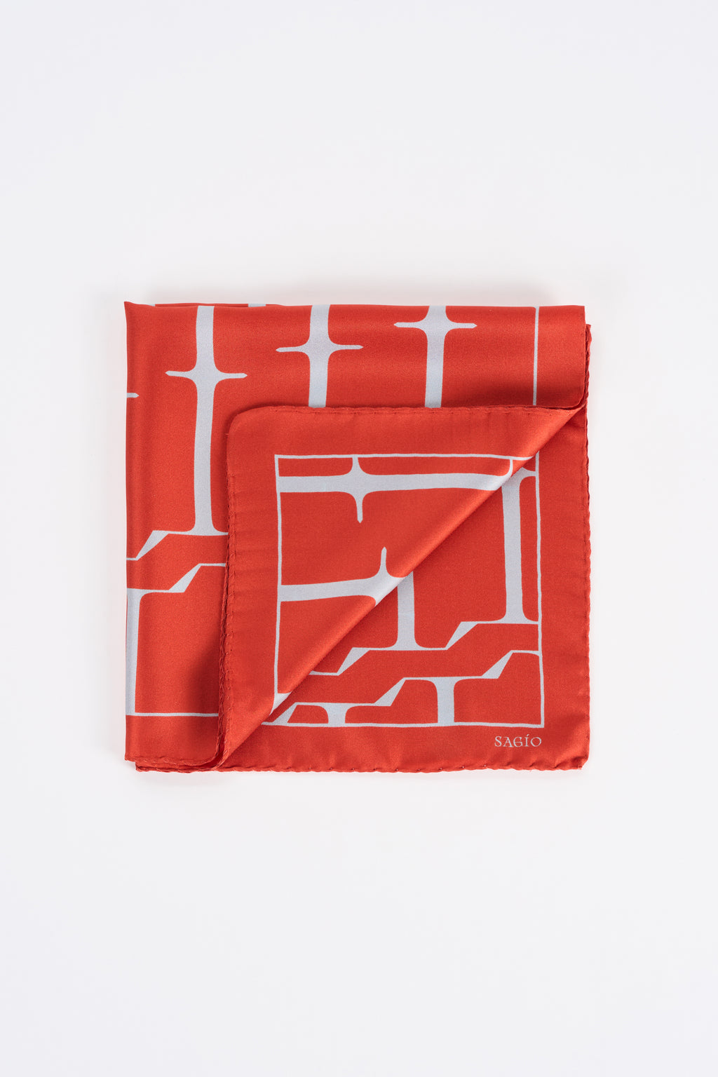 Vermilion red twill silk carré scarf with white SAGIO monogram print in folded view