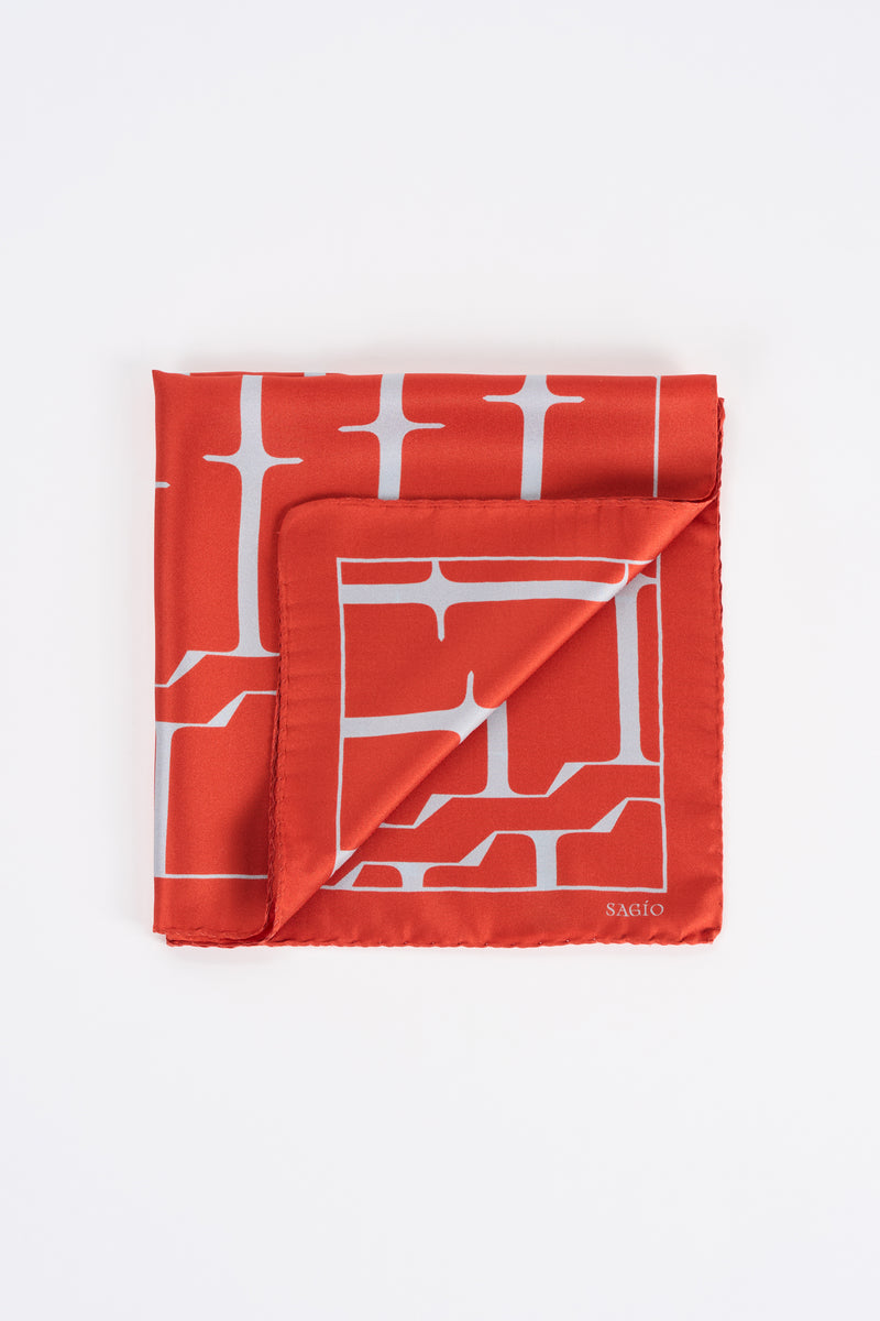Vermilion red twill silk carré scarf with white SAGIO monogram print in folded view